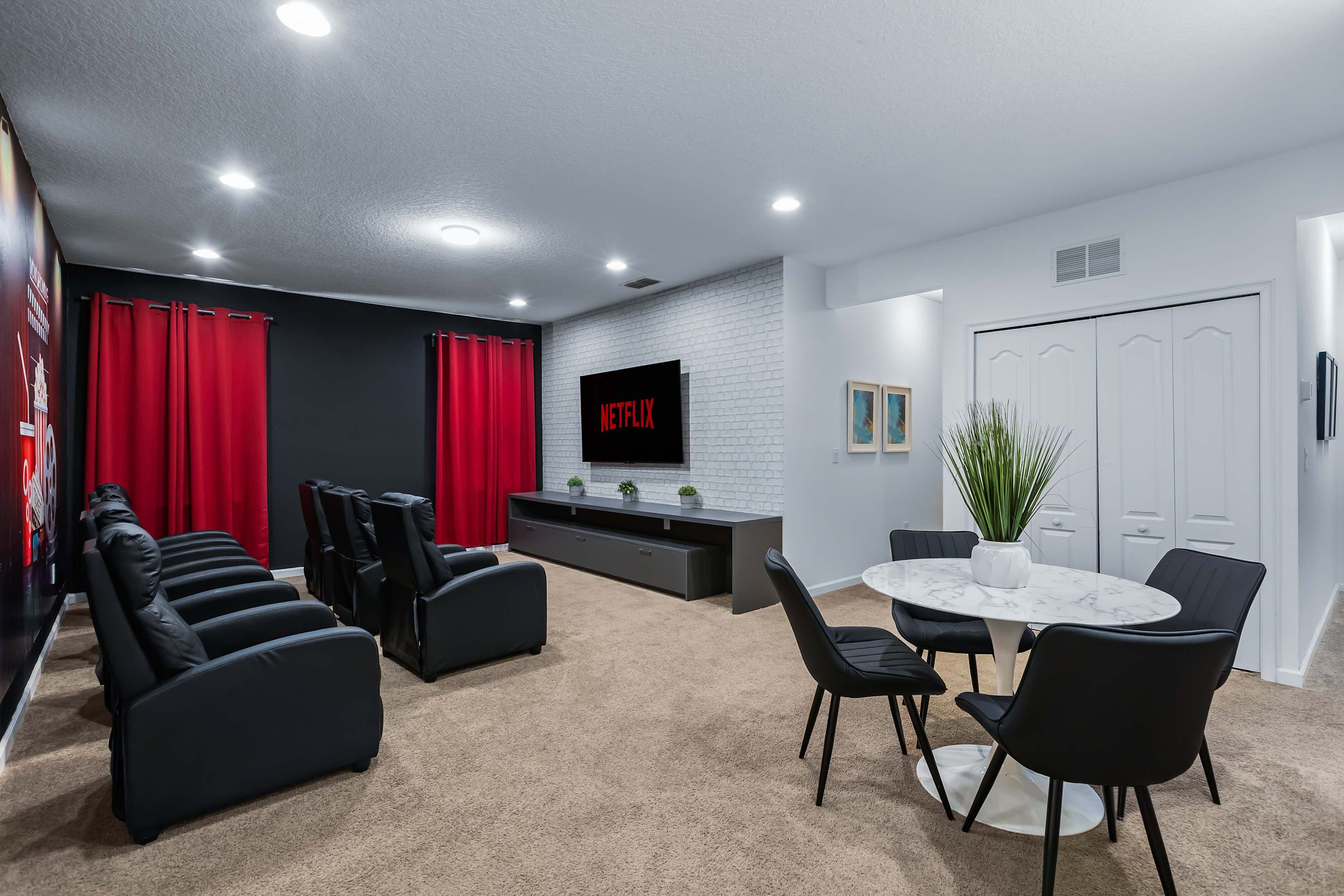 Spacious entertainment area with lounge seating and game table.