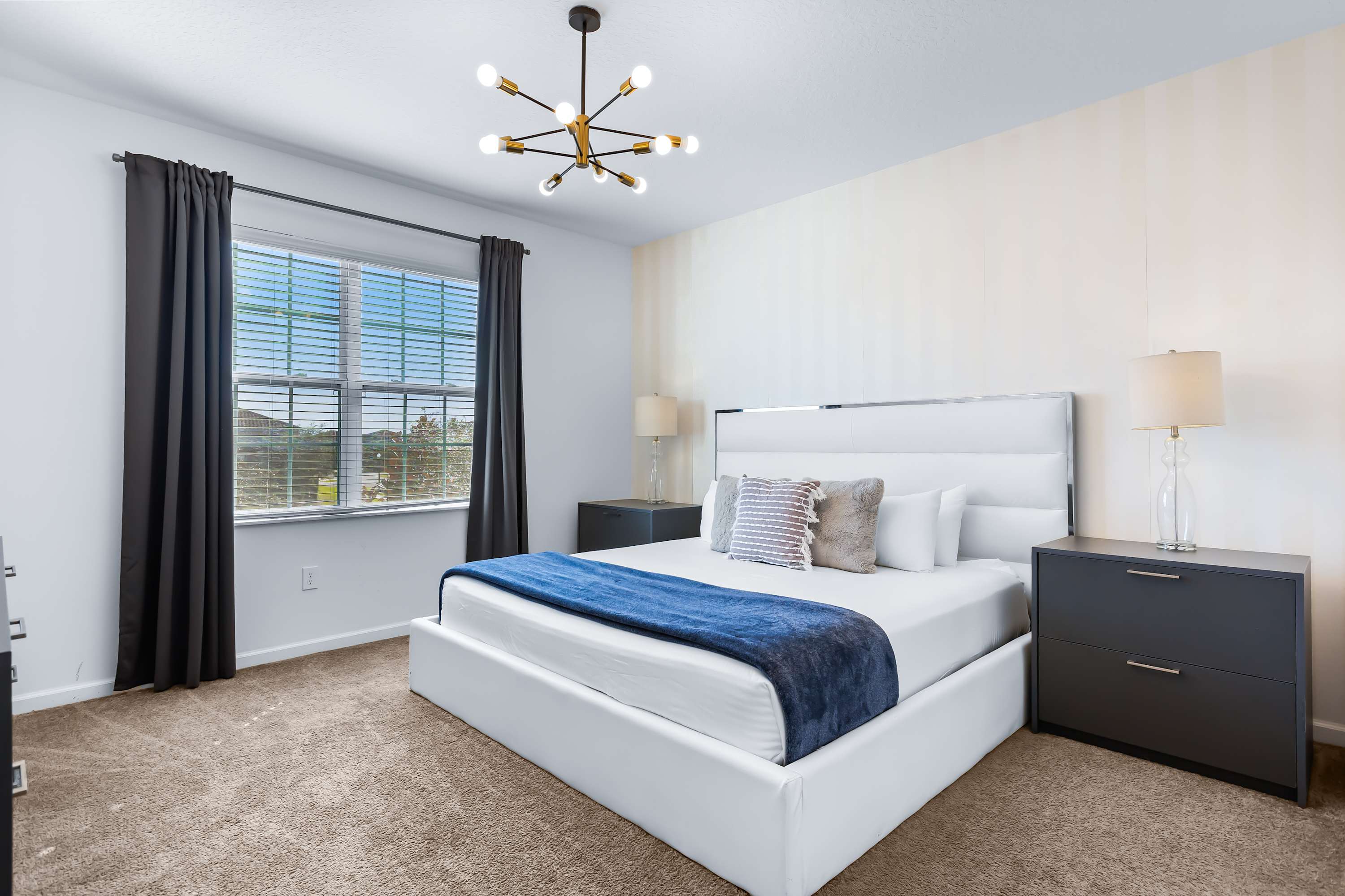 pacious master bedroom with king-size bed and natural light.