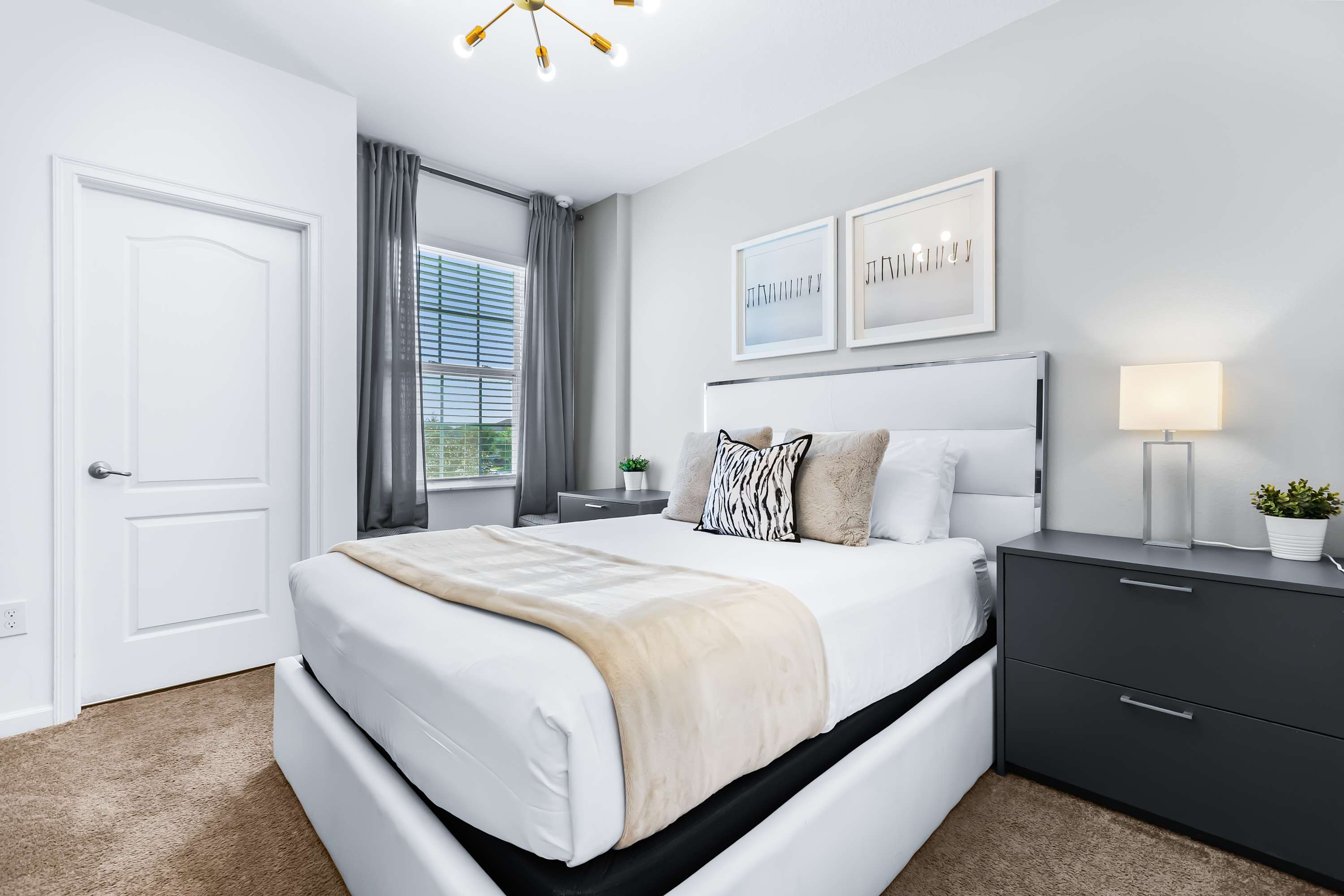 Cozy bedroom with soft lighting and comfortable bed.