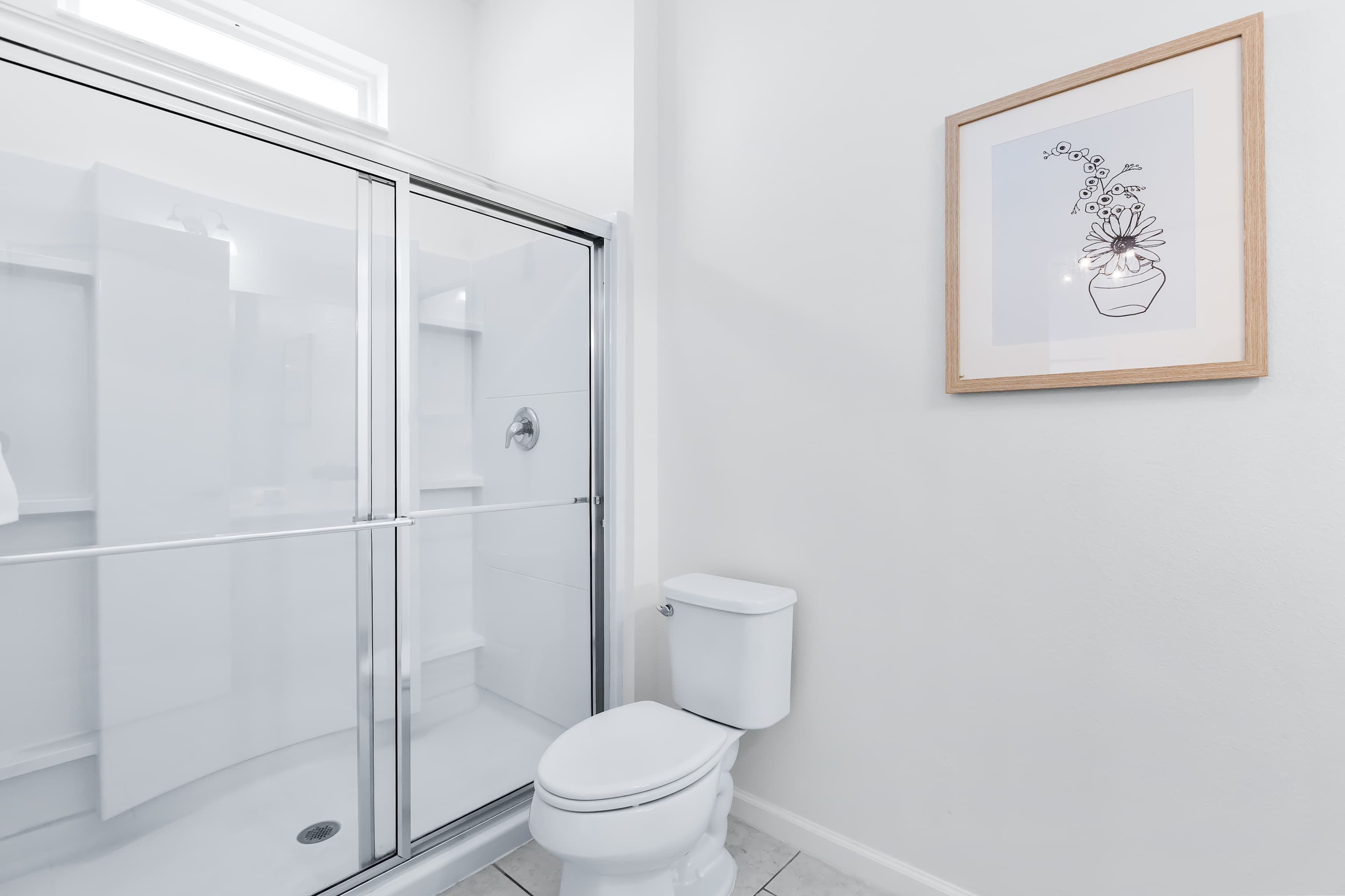 Bathroom with glass-enclosed shower and clean design.