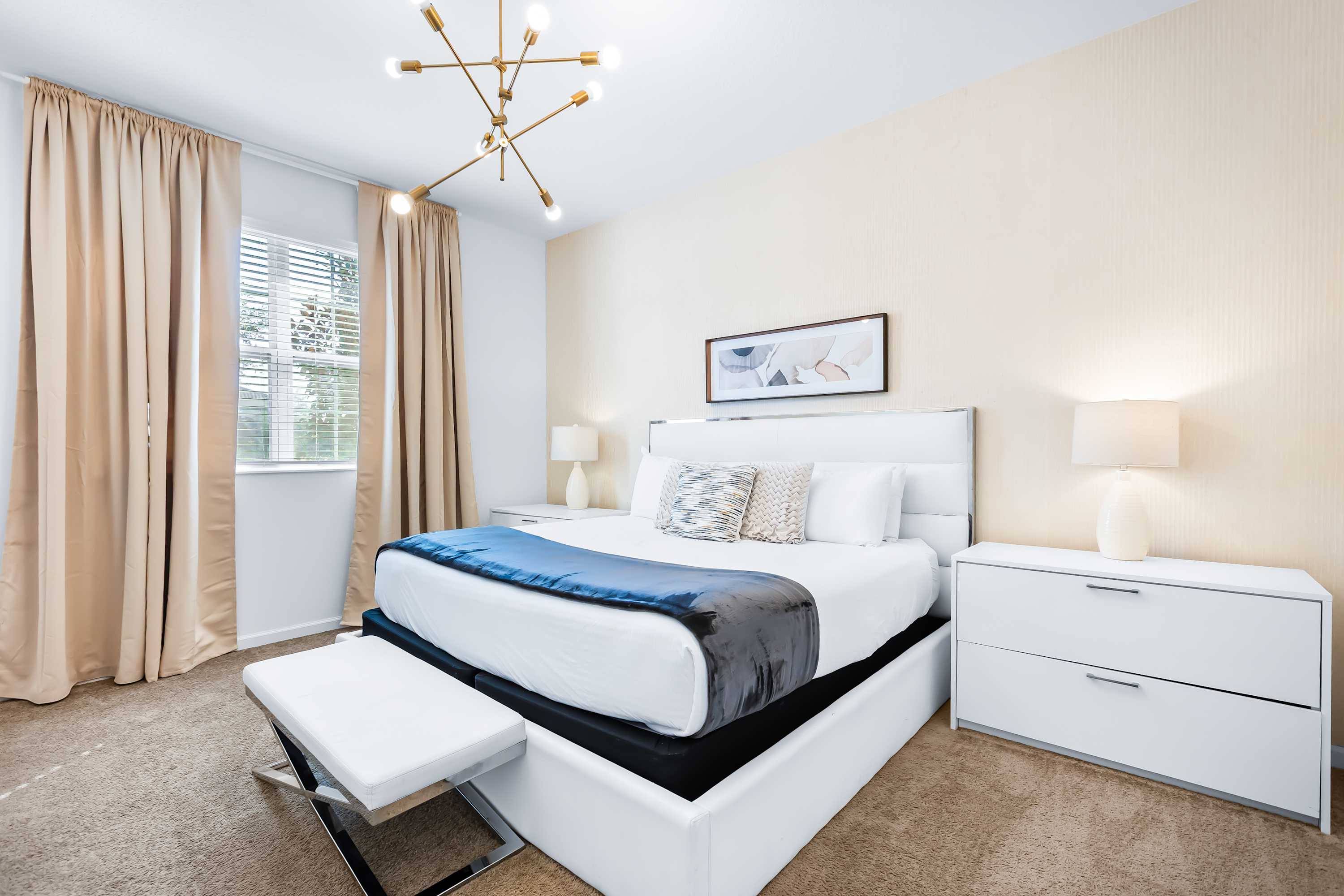 Cozy bedroom with soft lighting and comfortable bed.