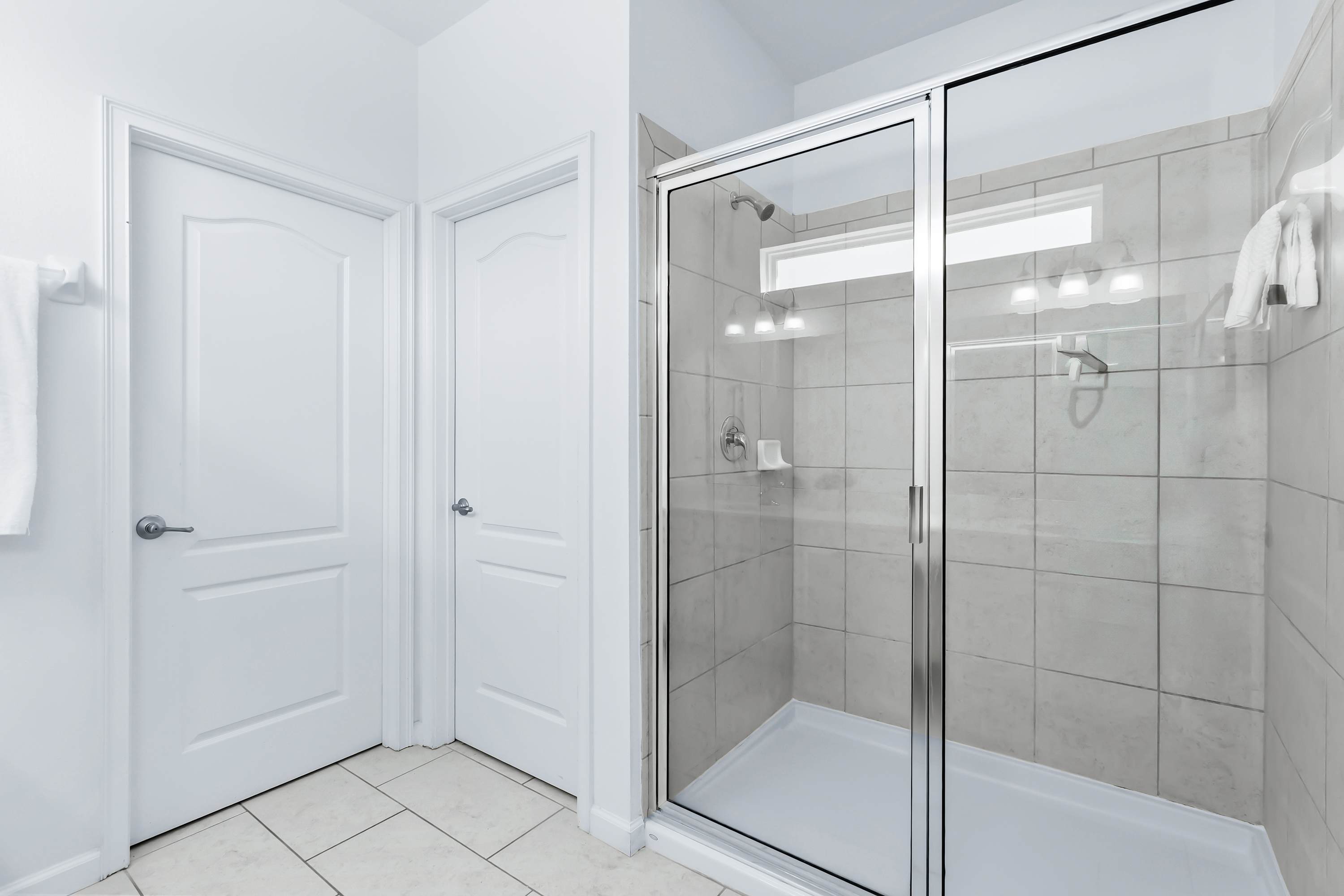 Bathroom with glass-enclosed shower and clean design.