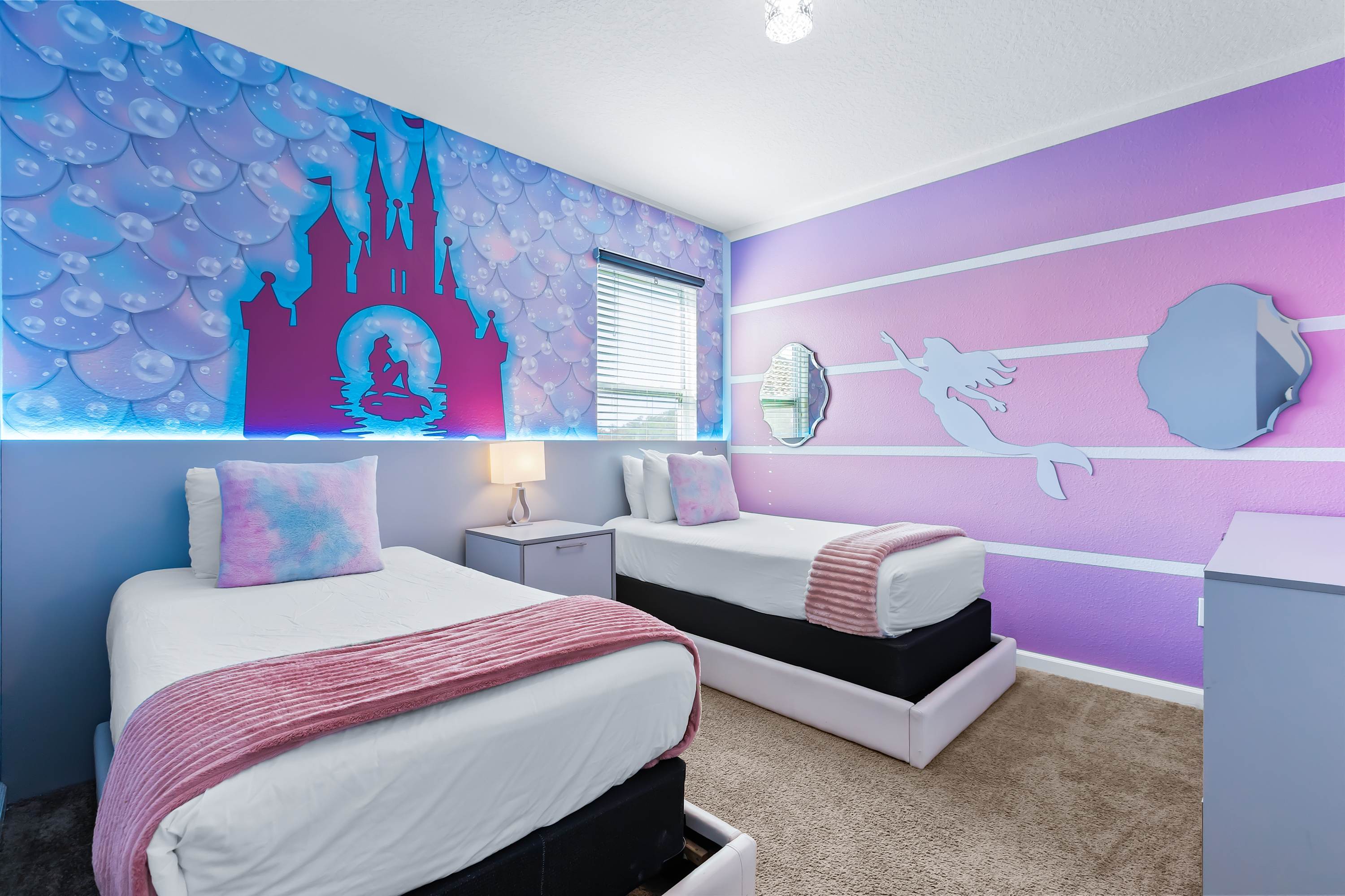 Princess themed bedroom with twin beds and whimsical décor.