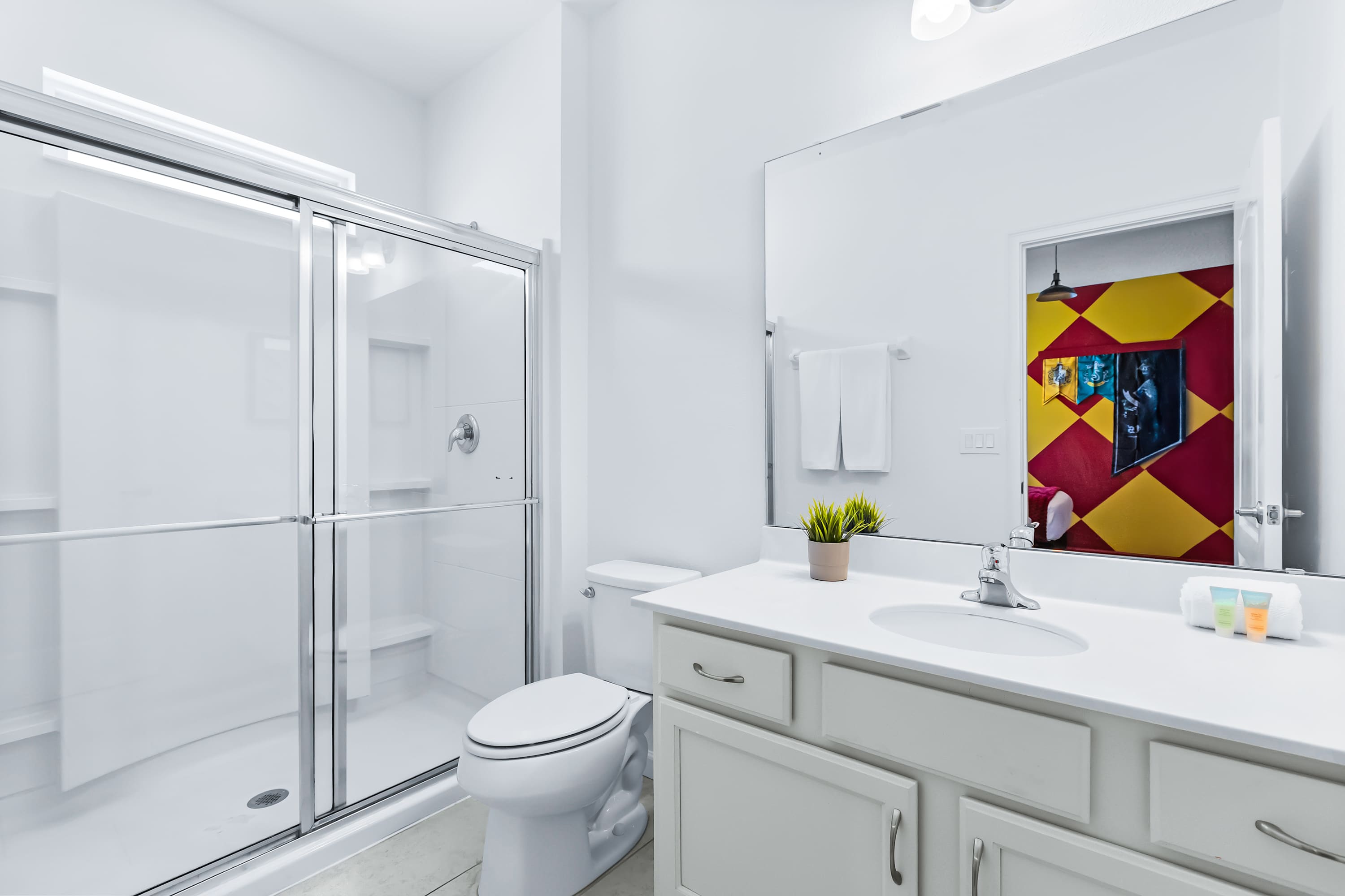 Modern bathroom with glass shower and clean, bright finishes.