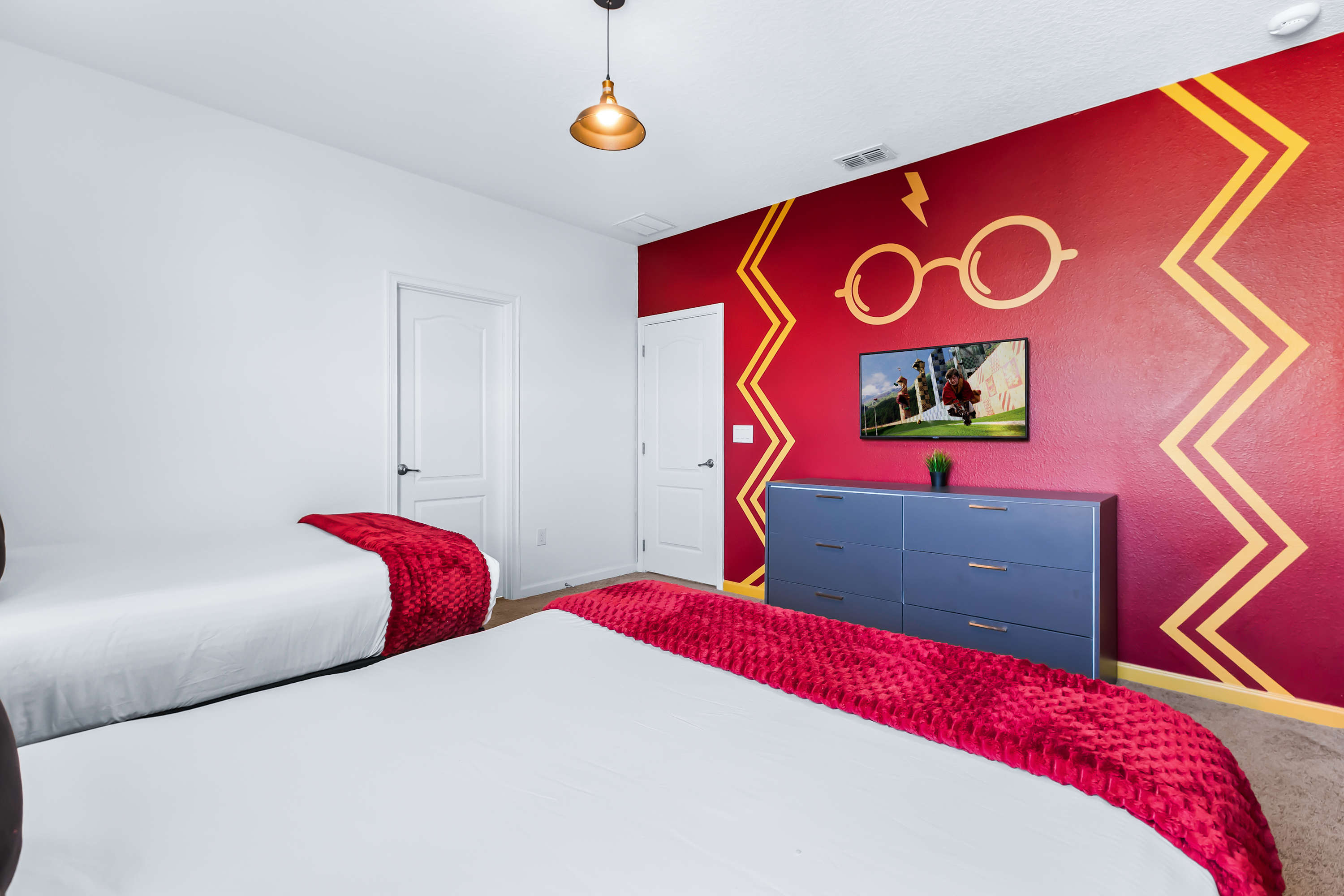 Magical themed bedroom with cozy beds and bold design details.