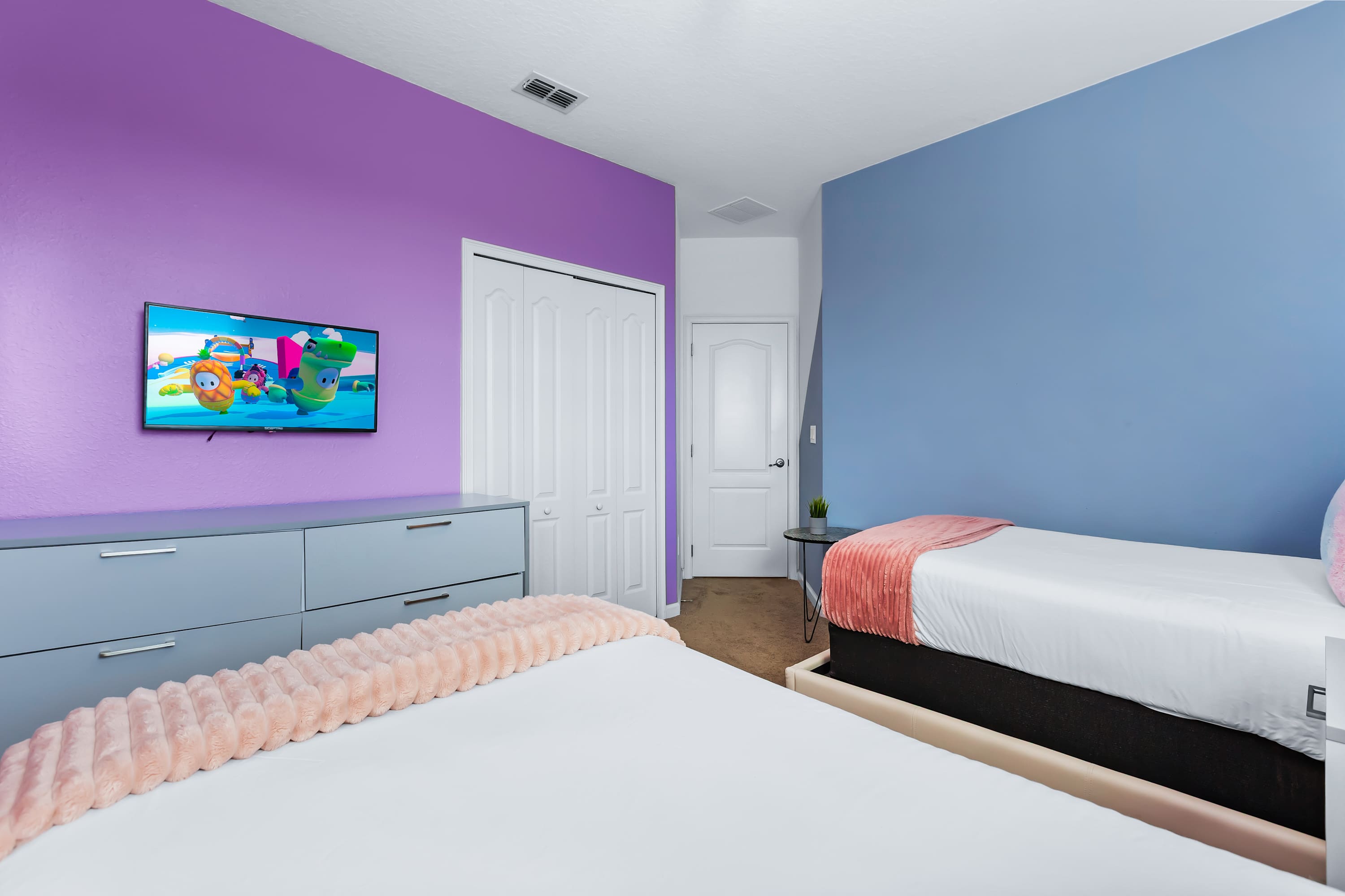 Comfortable bedroom with TV and modern, colorful design.