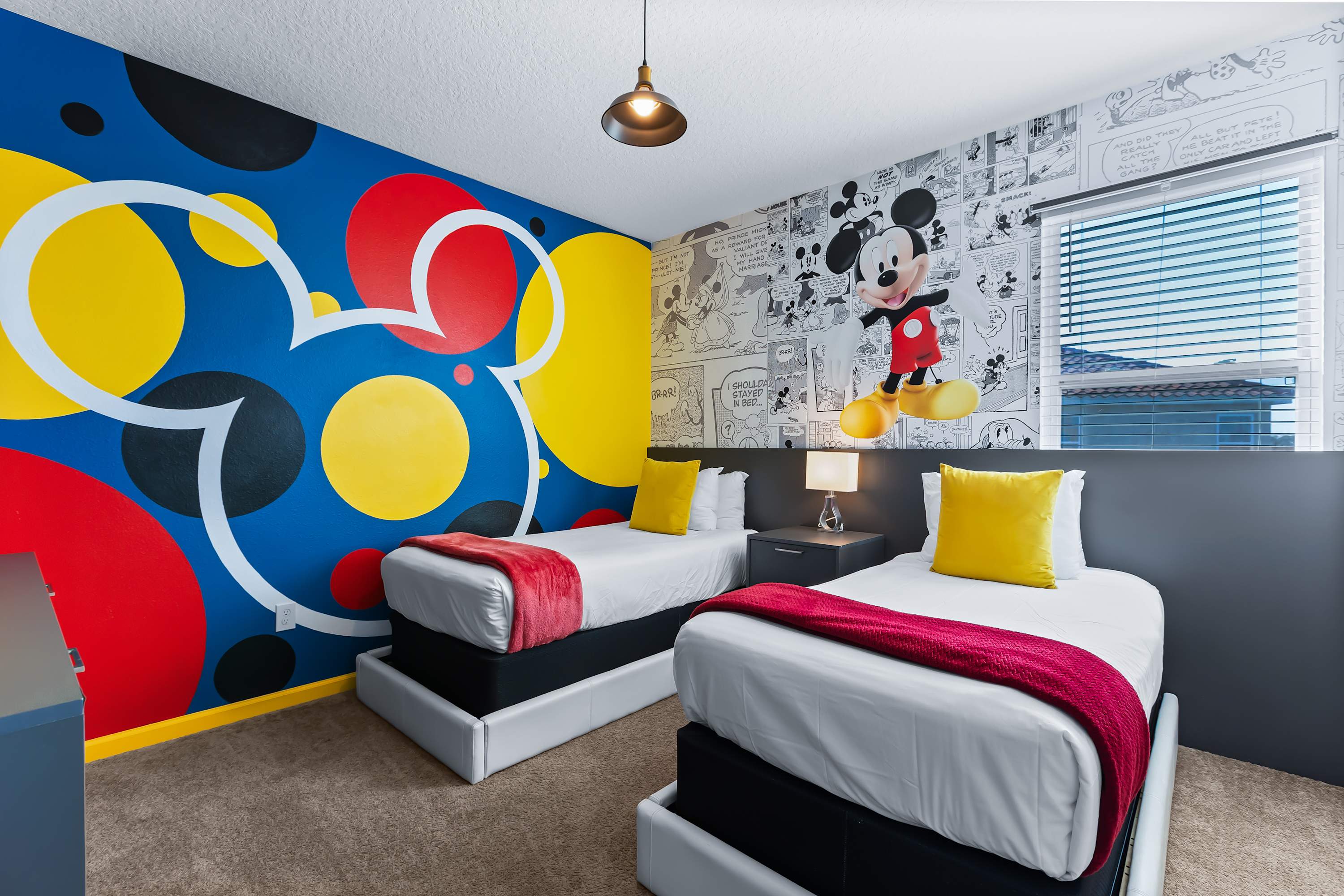 Mickey Mouse themed bedroom with twin beds and playful décor.