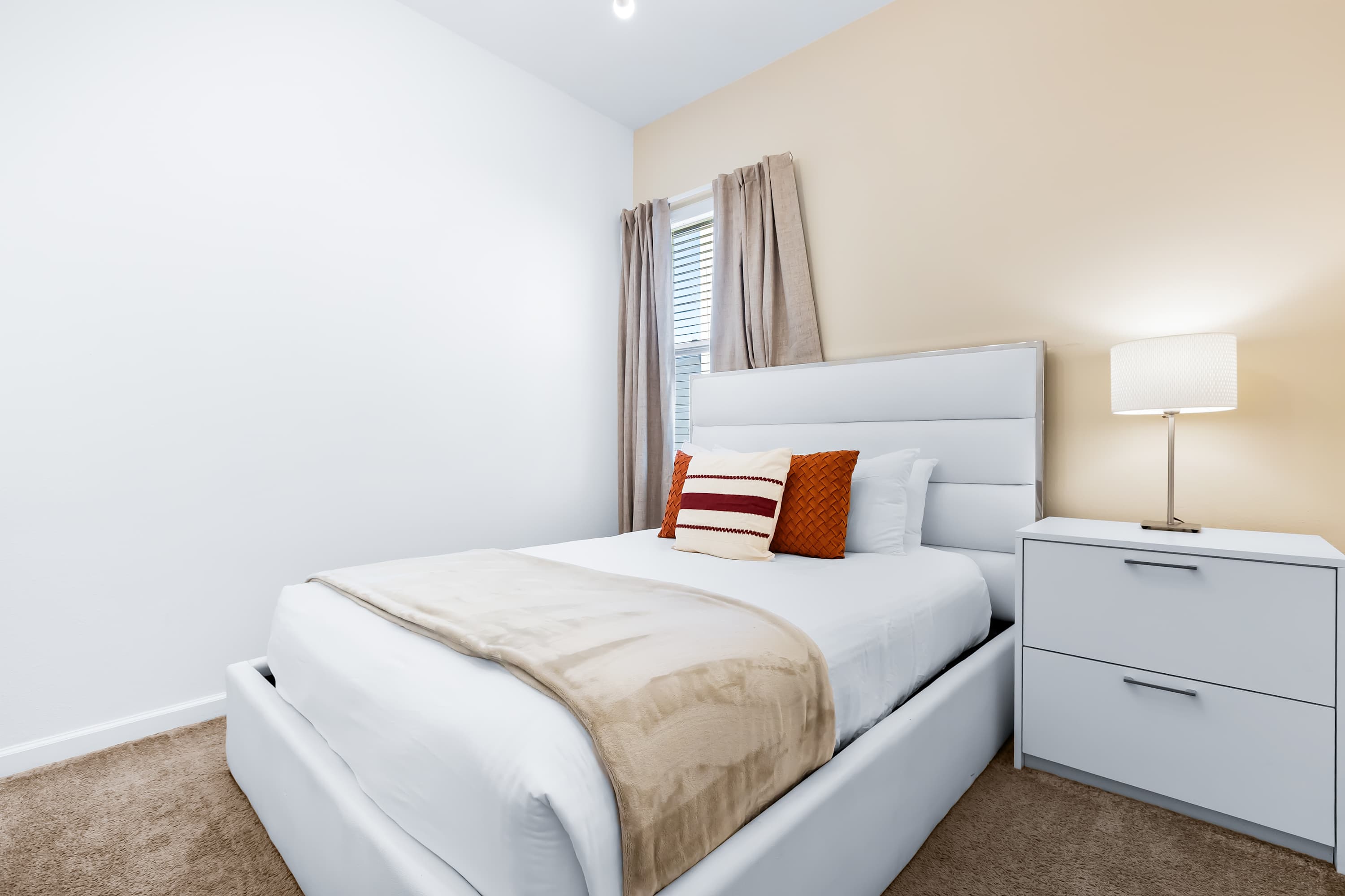 Cozy bedroom with soft lighting and comfortable bed.