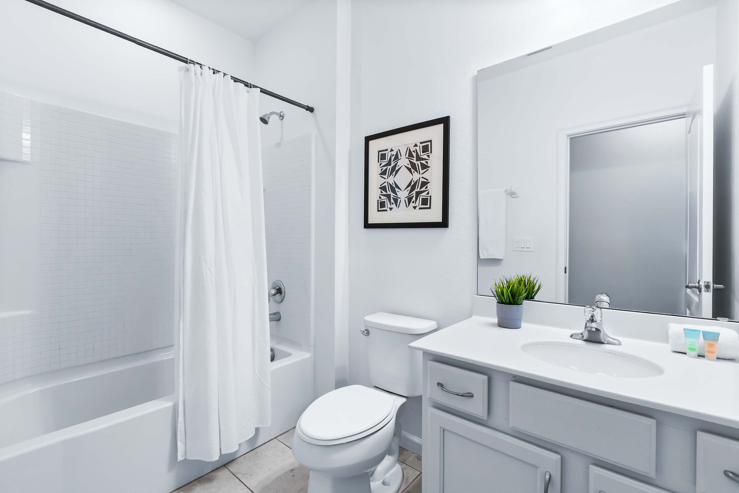 Clean and modern bathroom with shower and bright finishes.