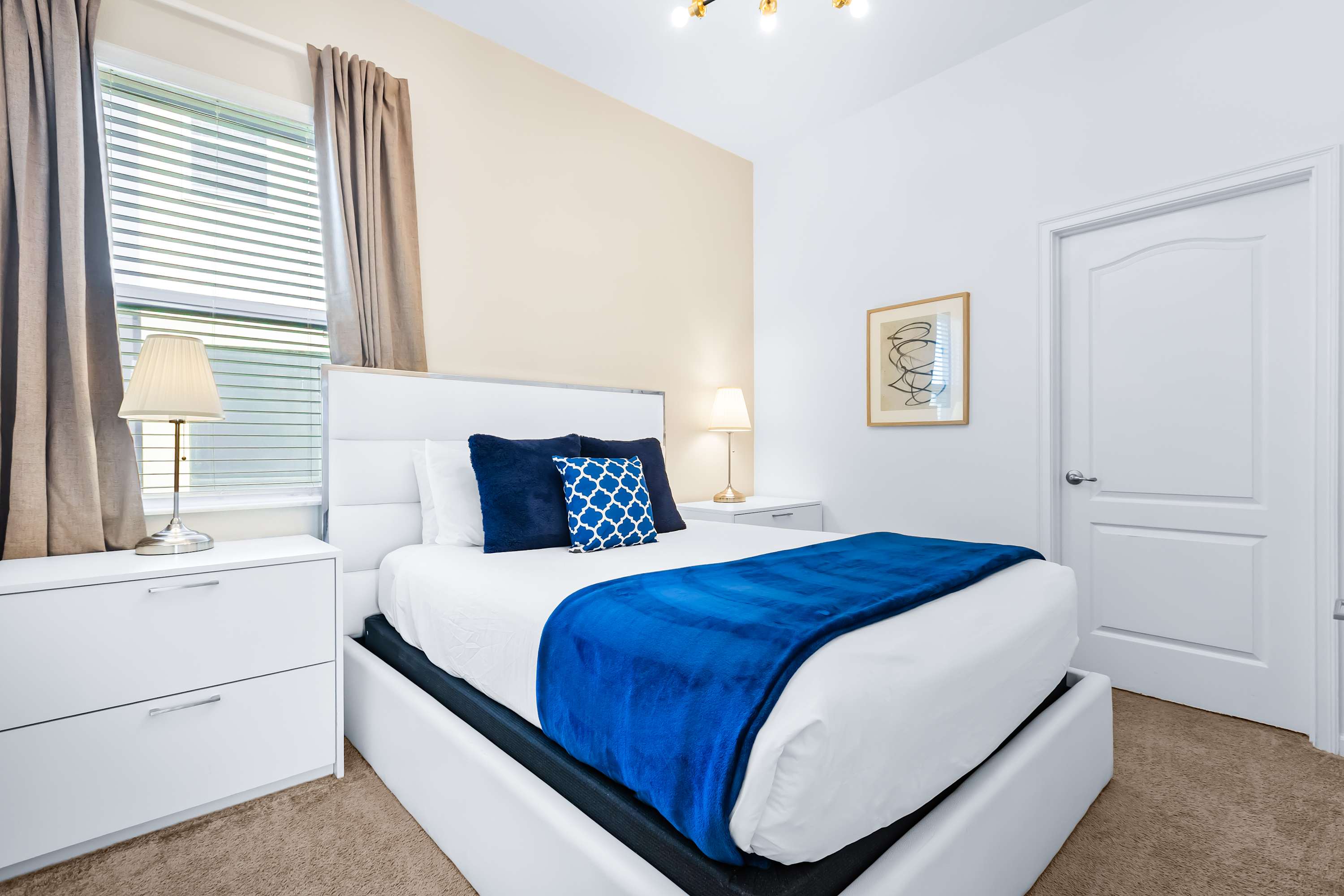 Cozy bedroom with soft lighting and comfortable bed.