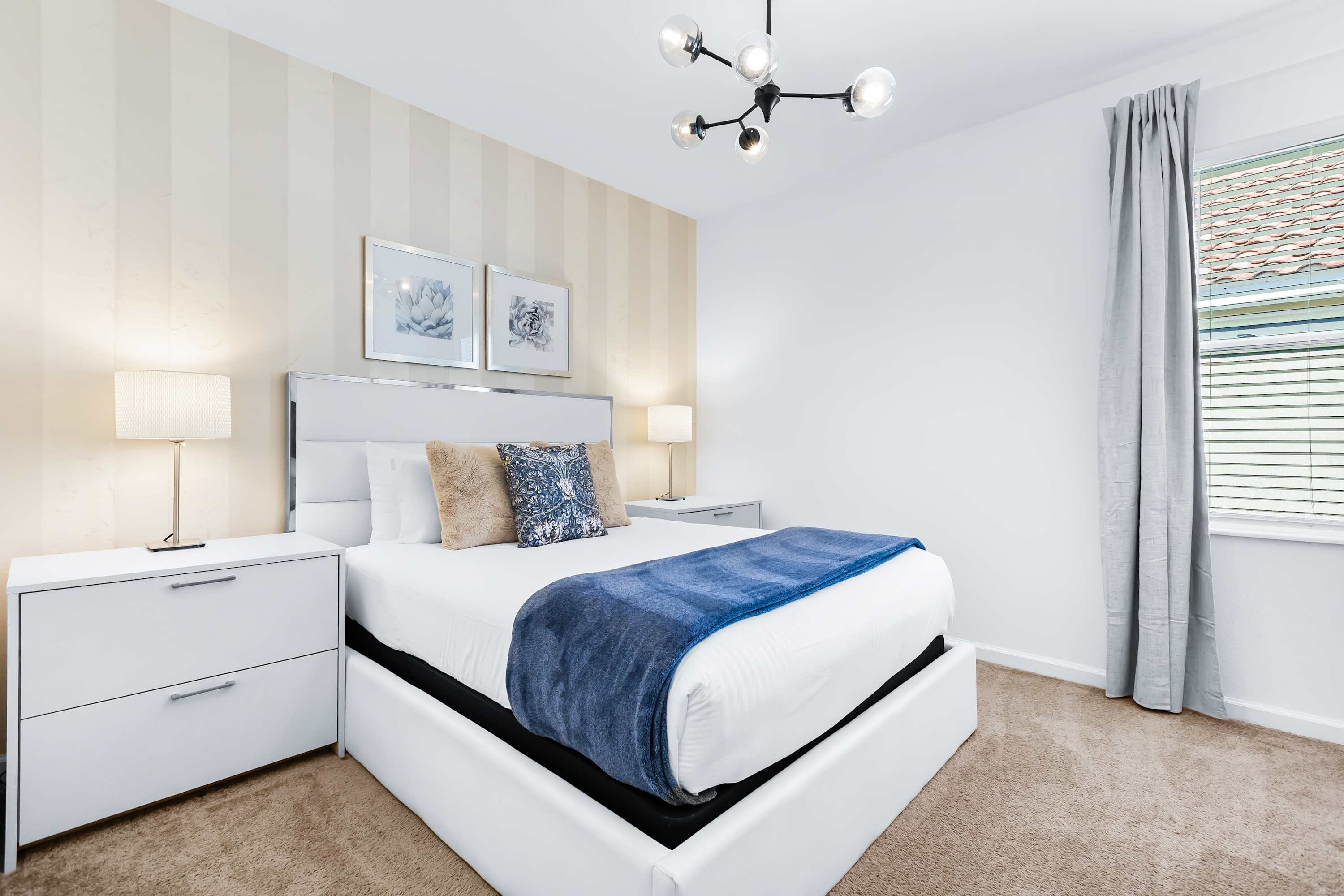 Cozy bedroom with soft lighting and comfortable bed.