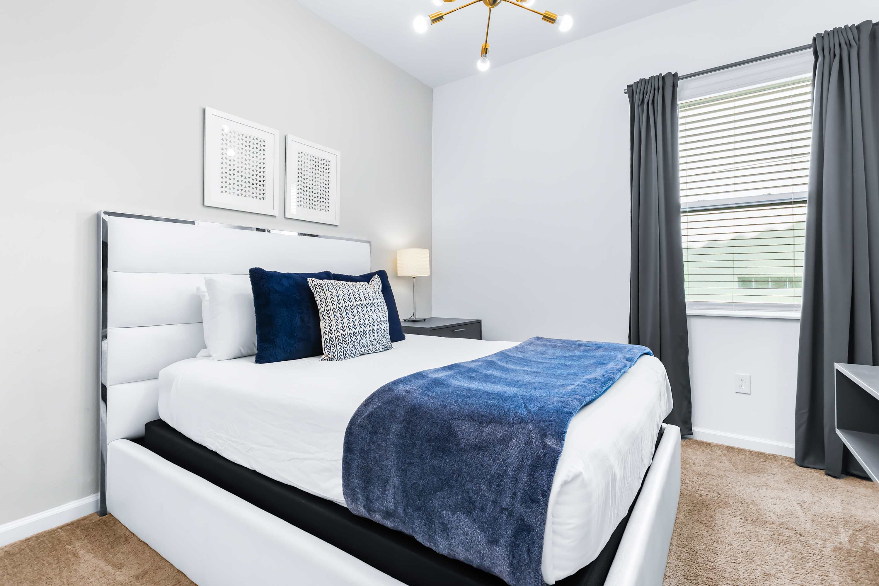 Cozy bedroom with soft lighting and comfortable bed.