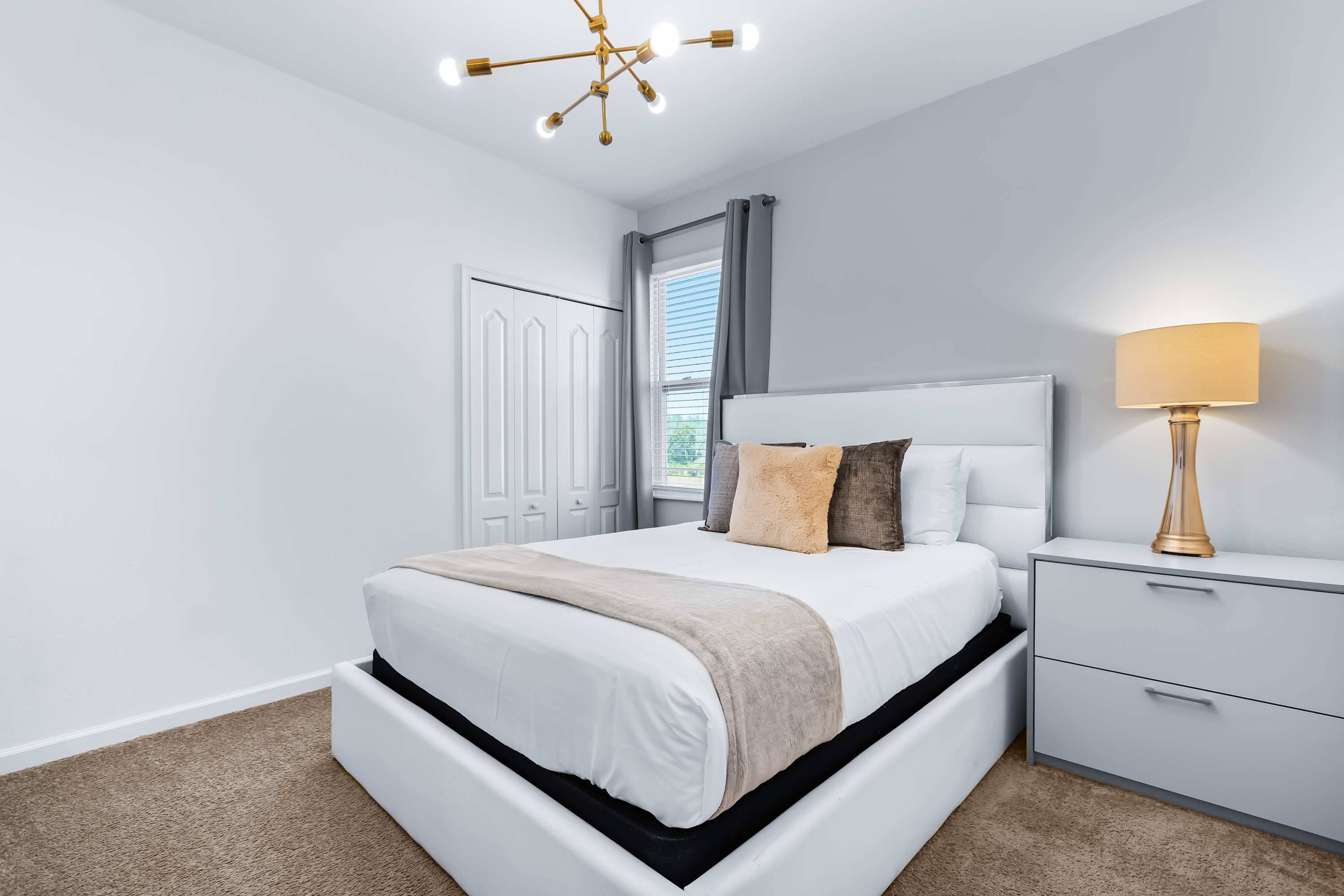 Cozy bedroom with soft lighting and comfortable bed.