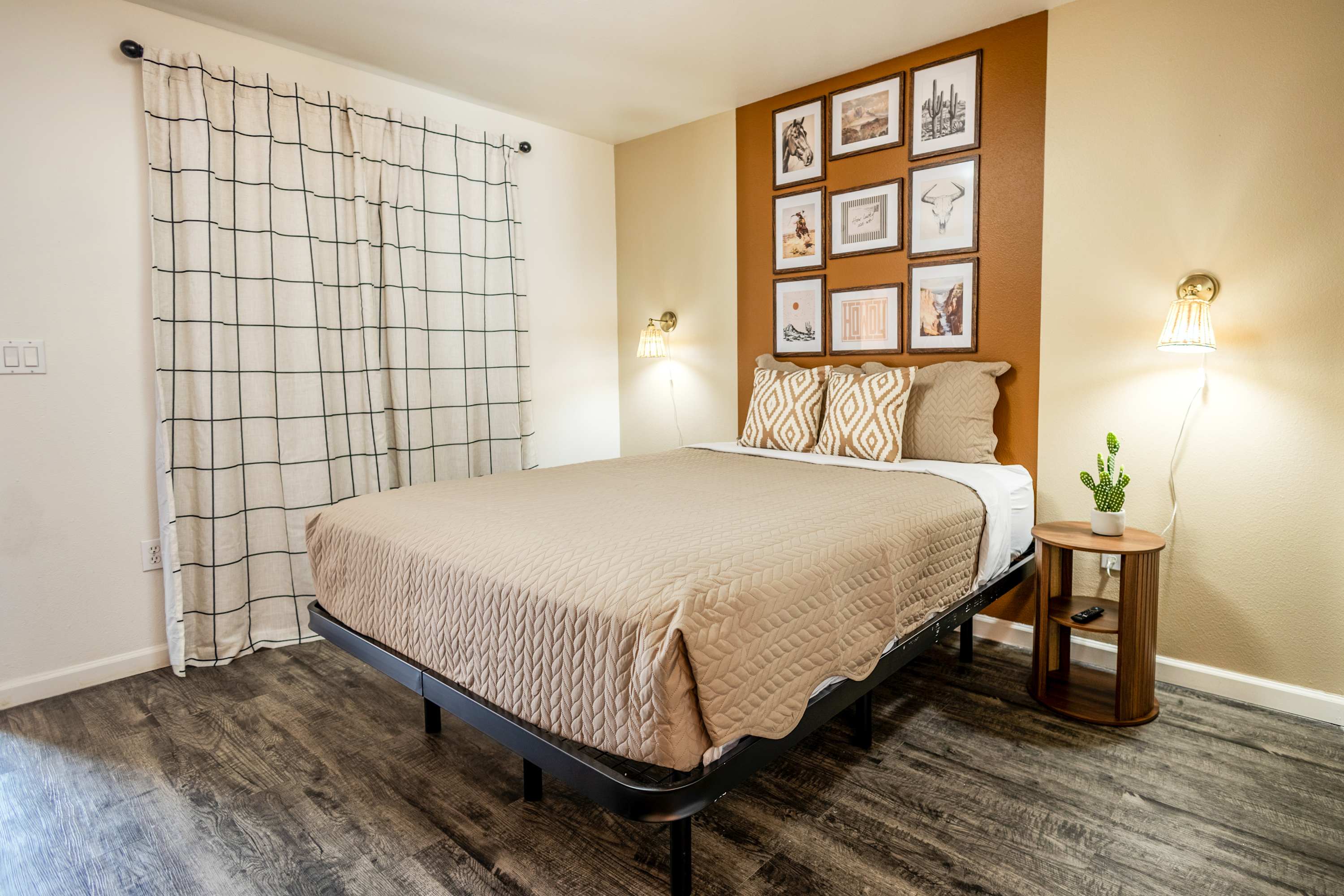 Cozy studio bedroom with stylish decor and warm lighting, perfect for a relaxing stay.