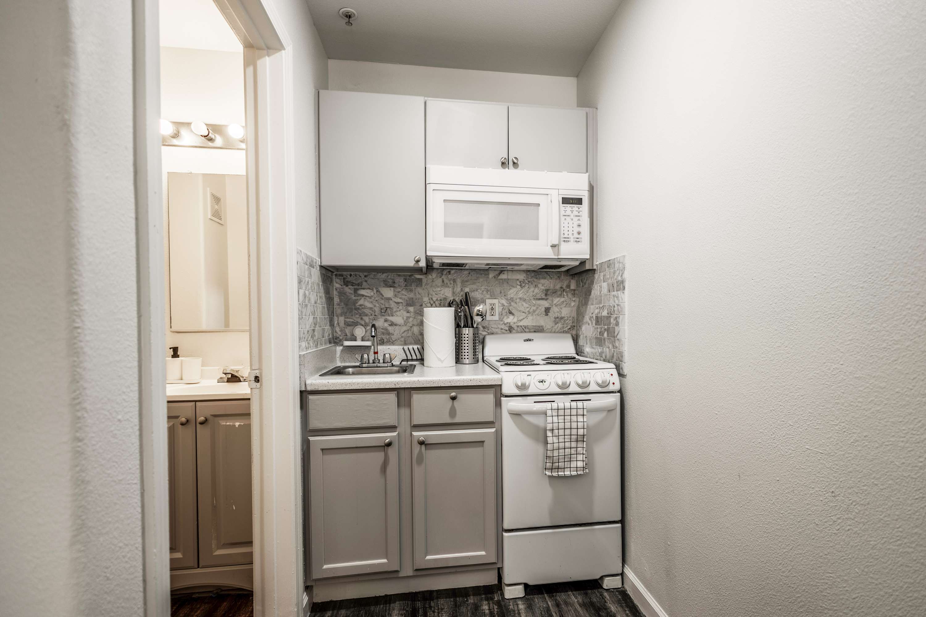 Efficient kitchenette with modern appliances, ideal for quick meals in your cozy studio retreat.