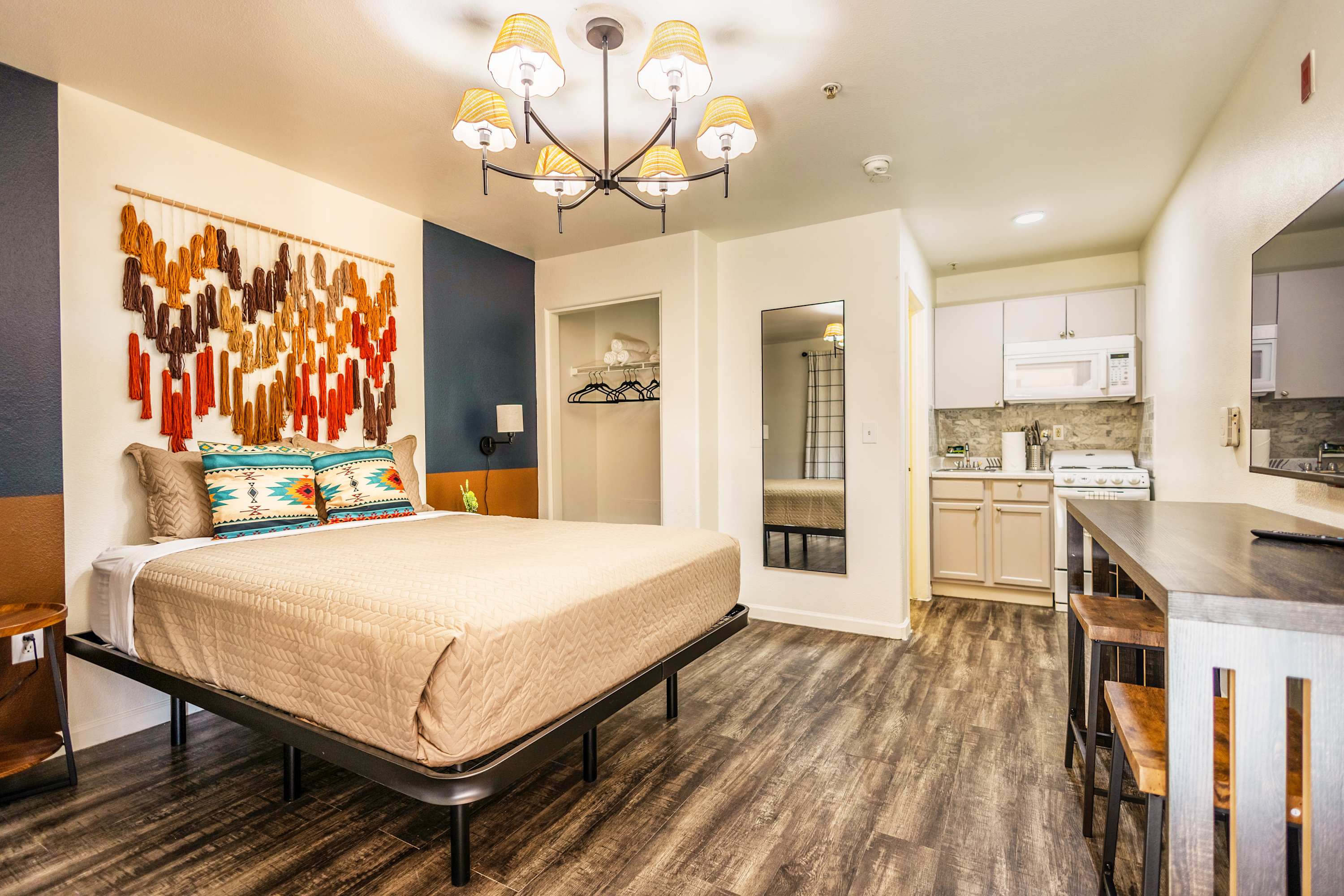Charming studio with vibrant decor and modern kitchenette, perfect for a cozy retreat.