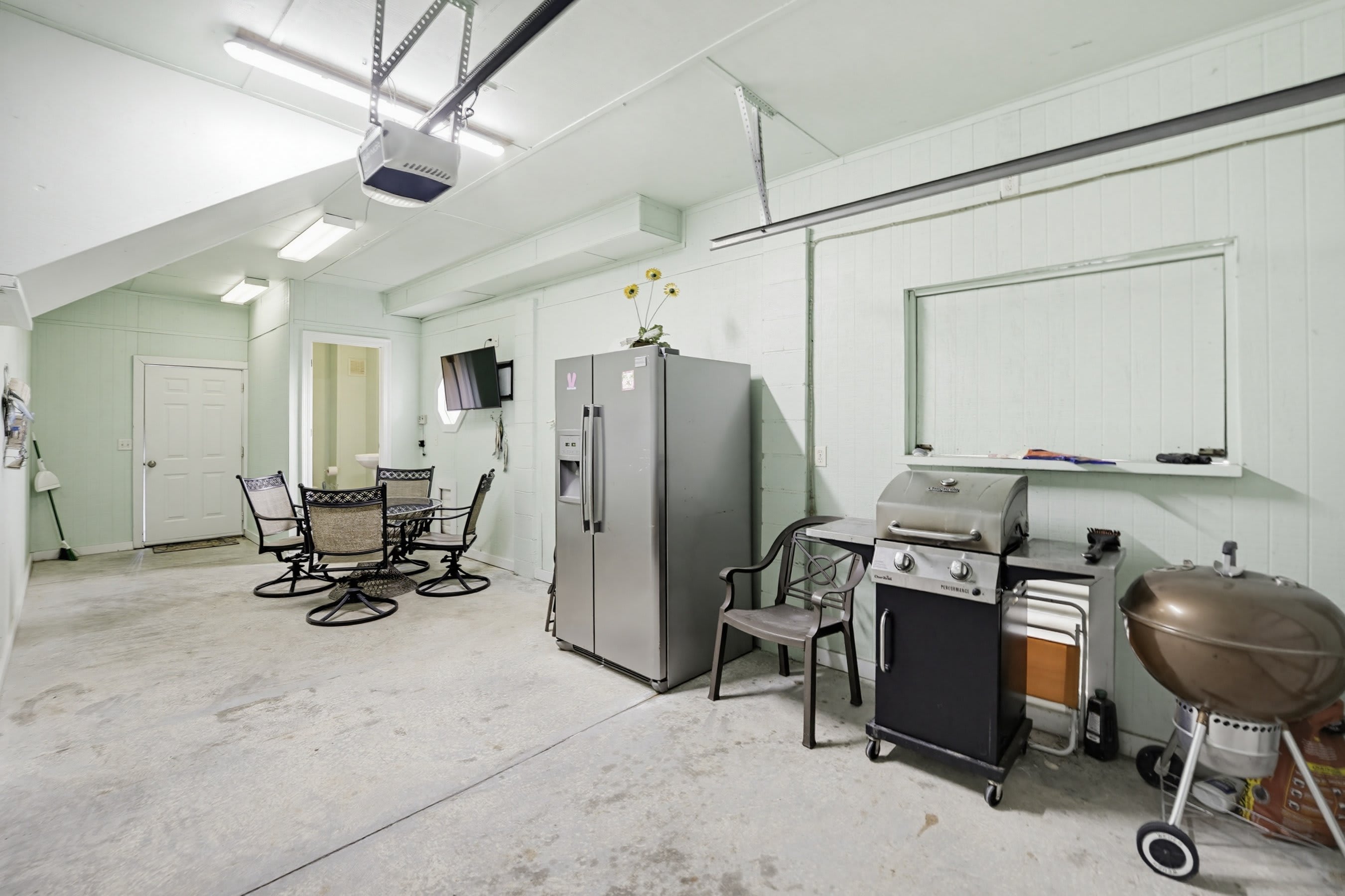 Garage with Extra Fridge, Grill, TV and Half Bath
