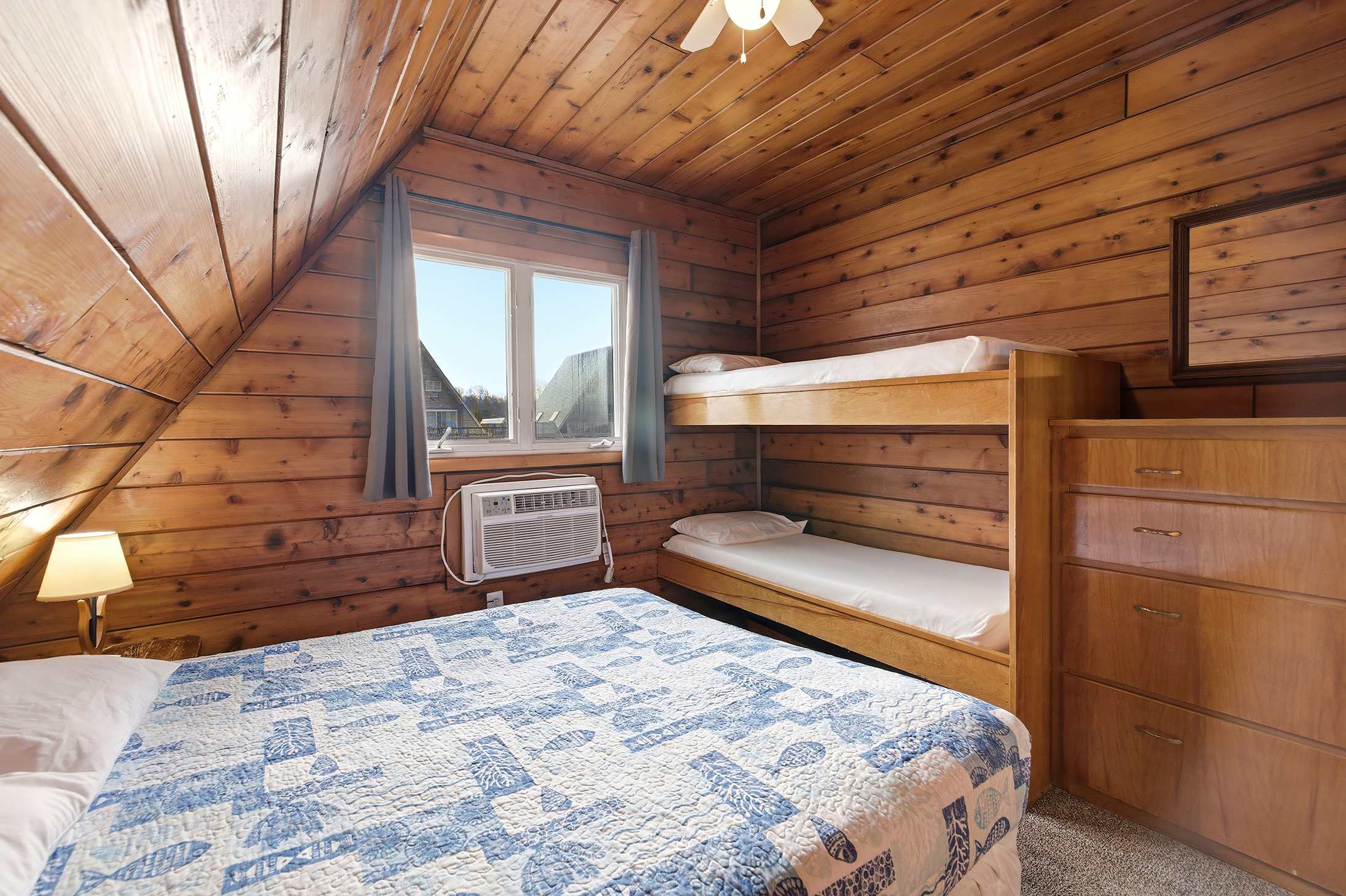 Bedroom 2 is on the upper level and has a queen and a single bunk bed.