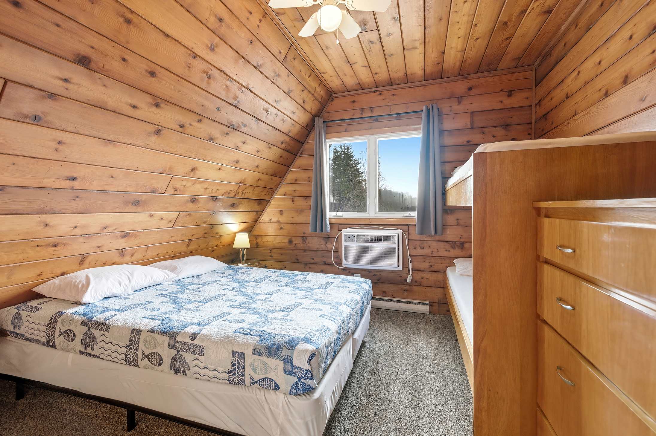 Warm walls, soft light, and a bed that earns its keep every night.