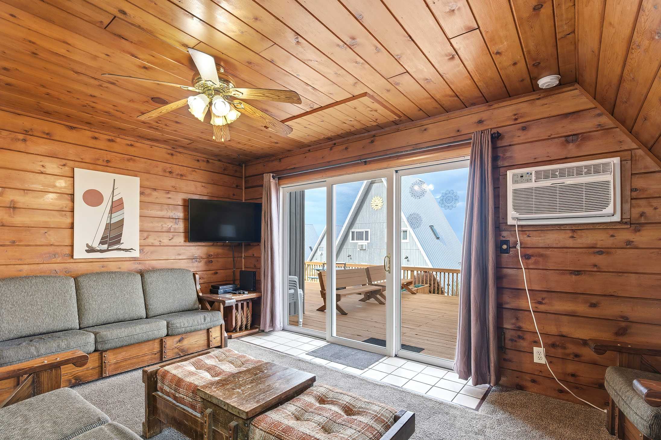 Airy living room with deck access near Lake Michigan shoreline.