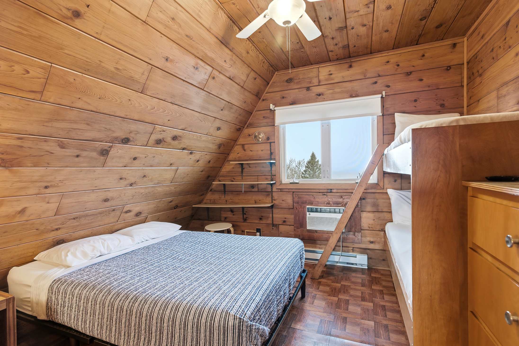 Bedroom 2 is on the upper level and has a queen and a single bunk bed.