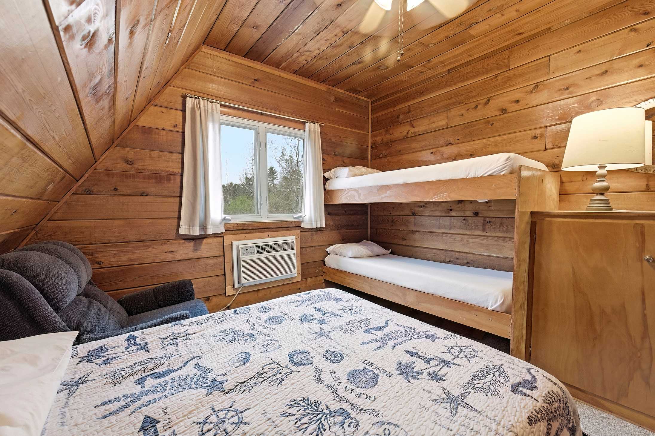 Bedroom 2 is on the upper level and has a queen and a single bunk bed.