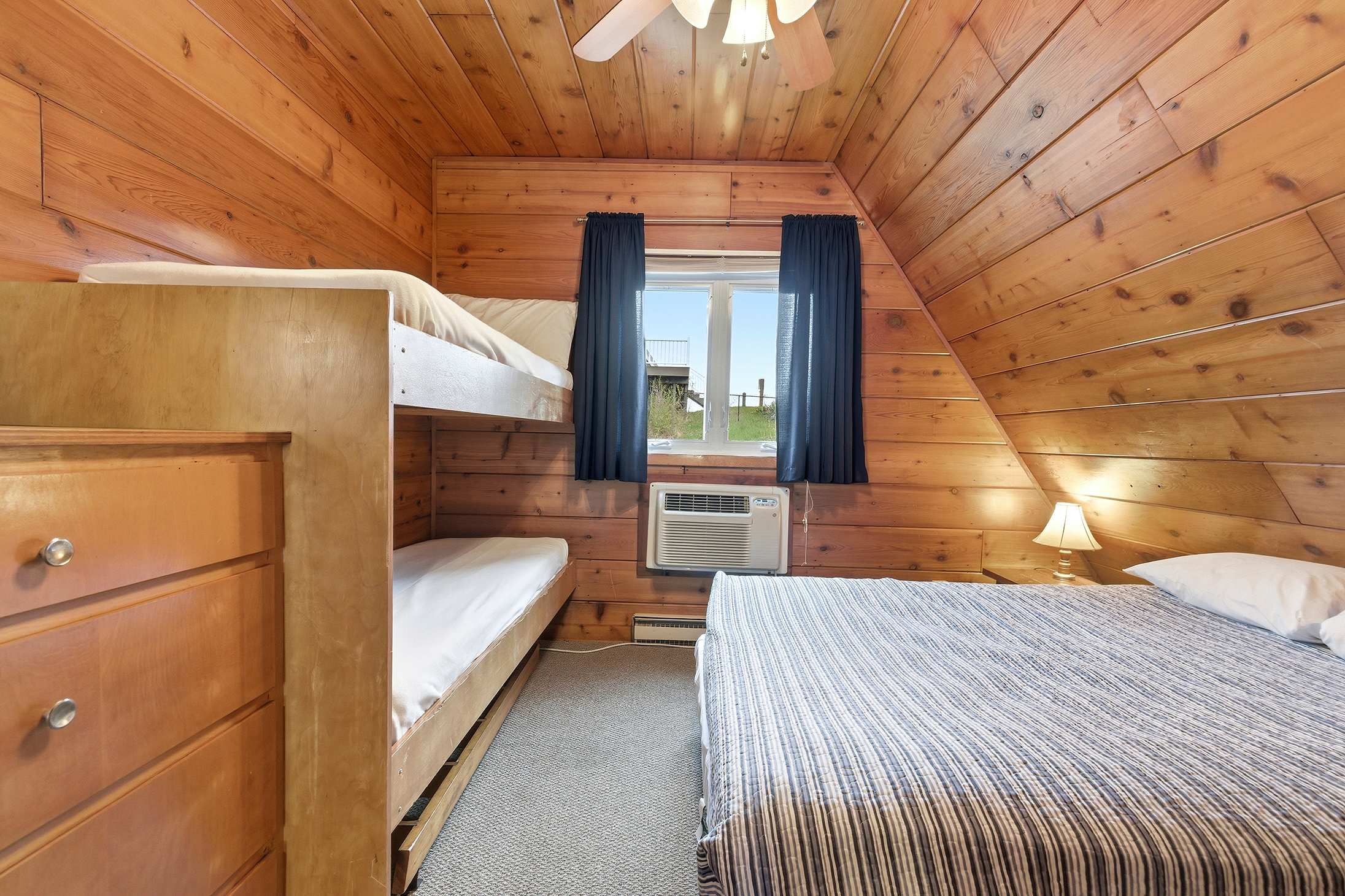 Bedroom 1 is on the upper level and has a queen and a single bunk bed.
