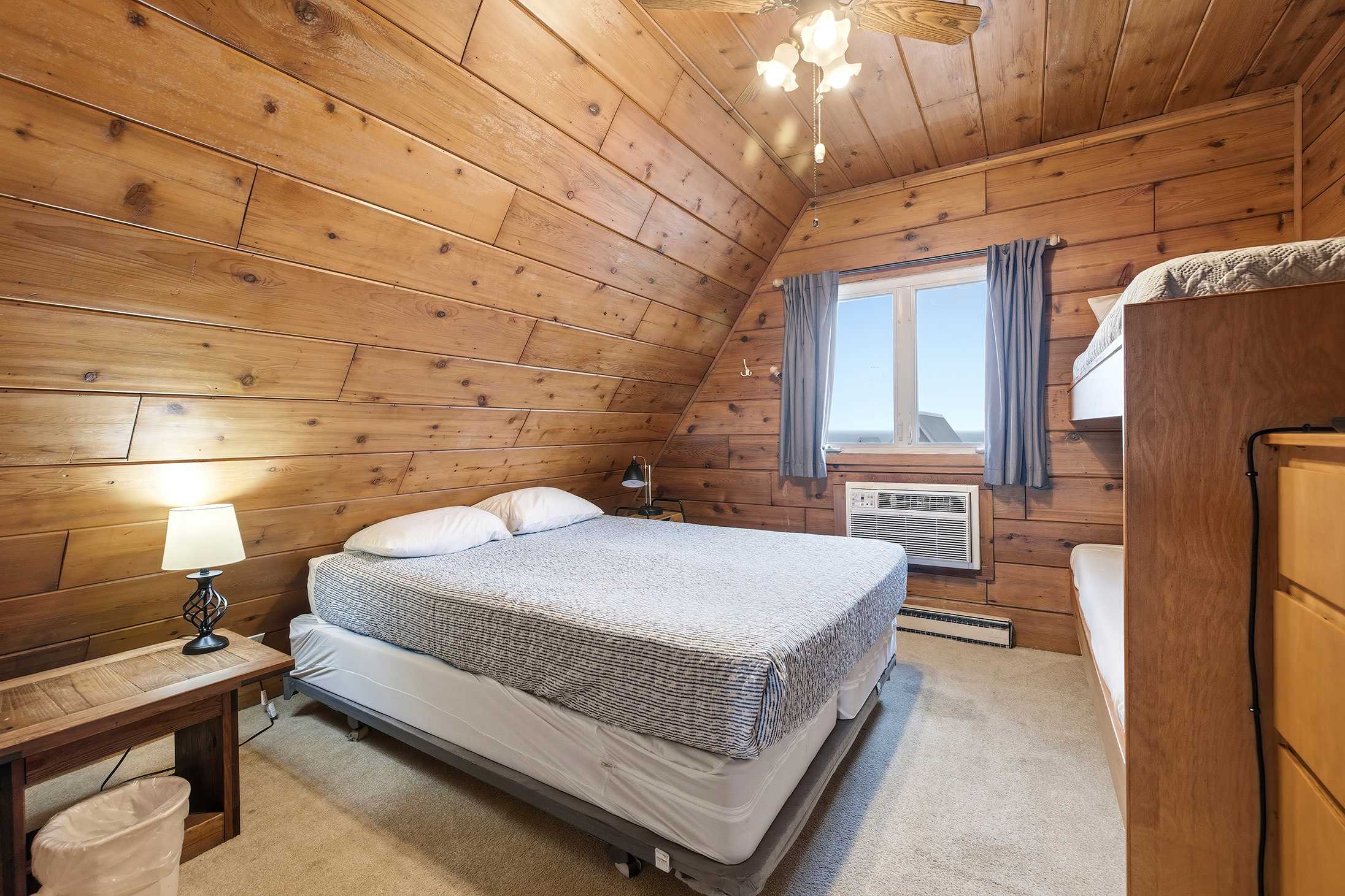 Bedroom 1 is on the upper level and has a queen and a single bunk bed.