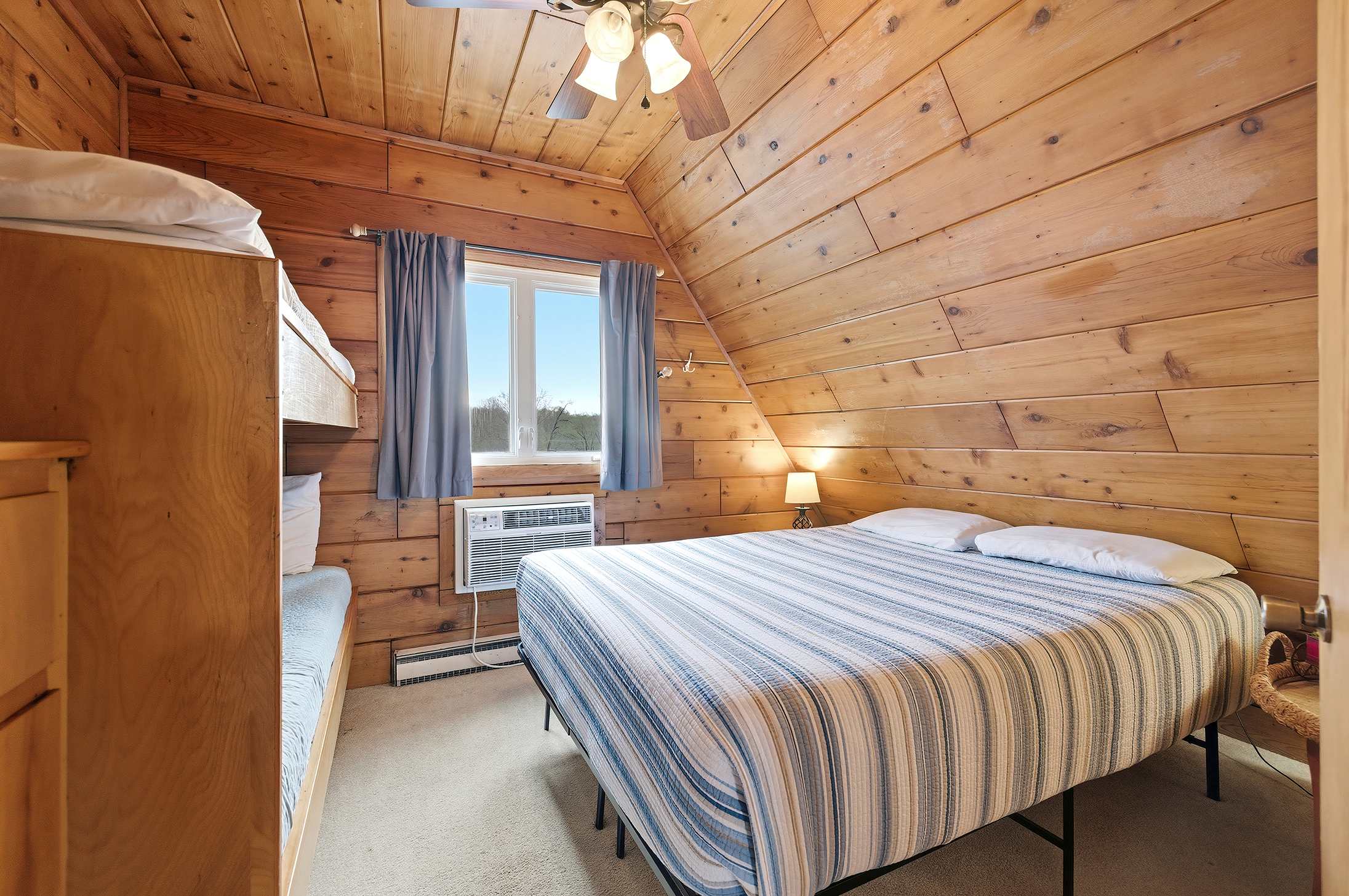 Bedroom 2 is on the upper level and has a queen and a single bunk bed.