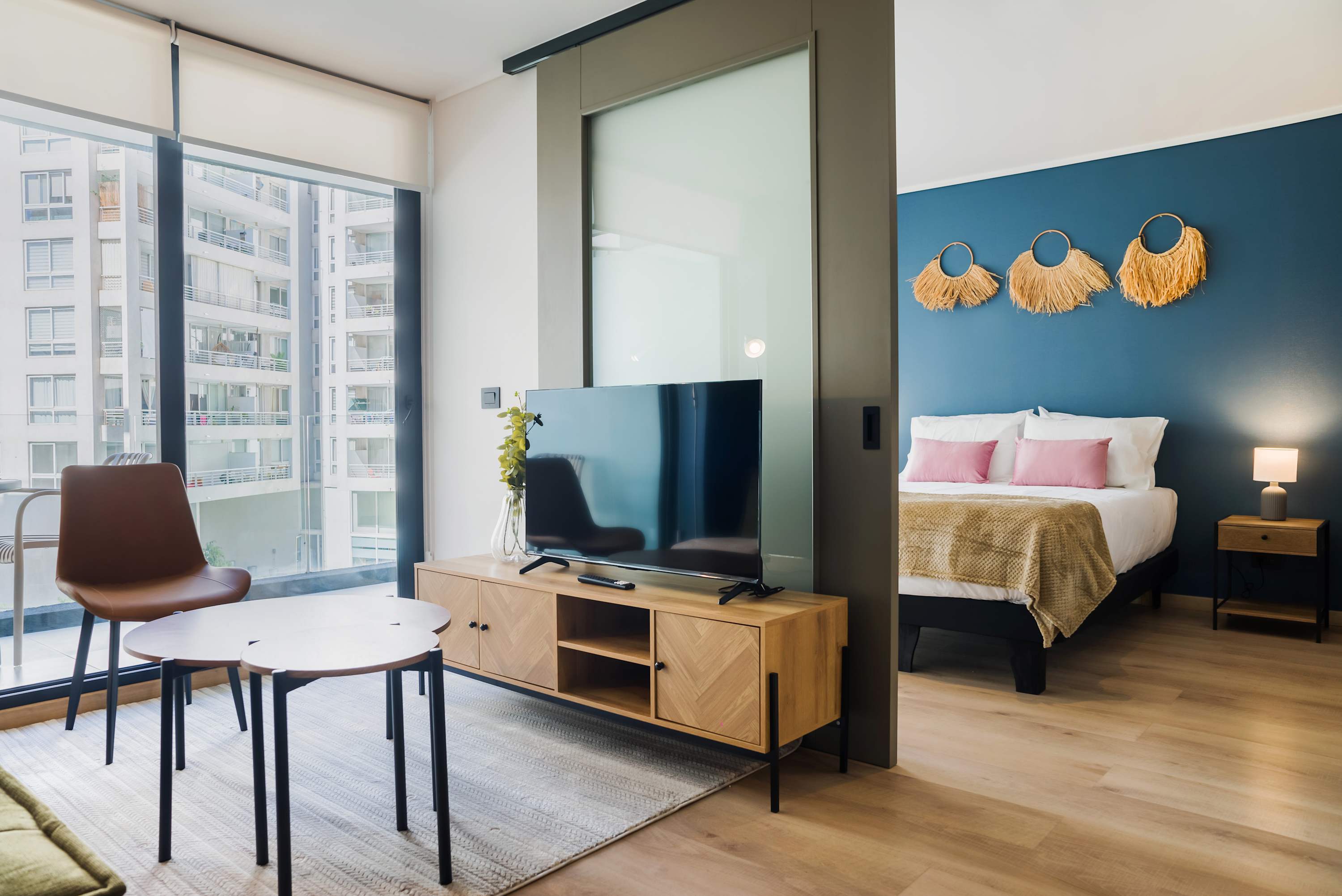 Modern studio with stylish decor, natural light, and cozy furnishings for a relaxing stay.