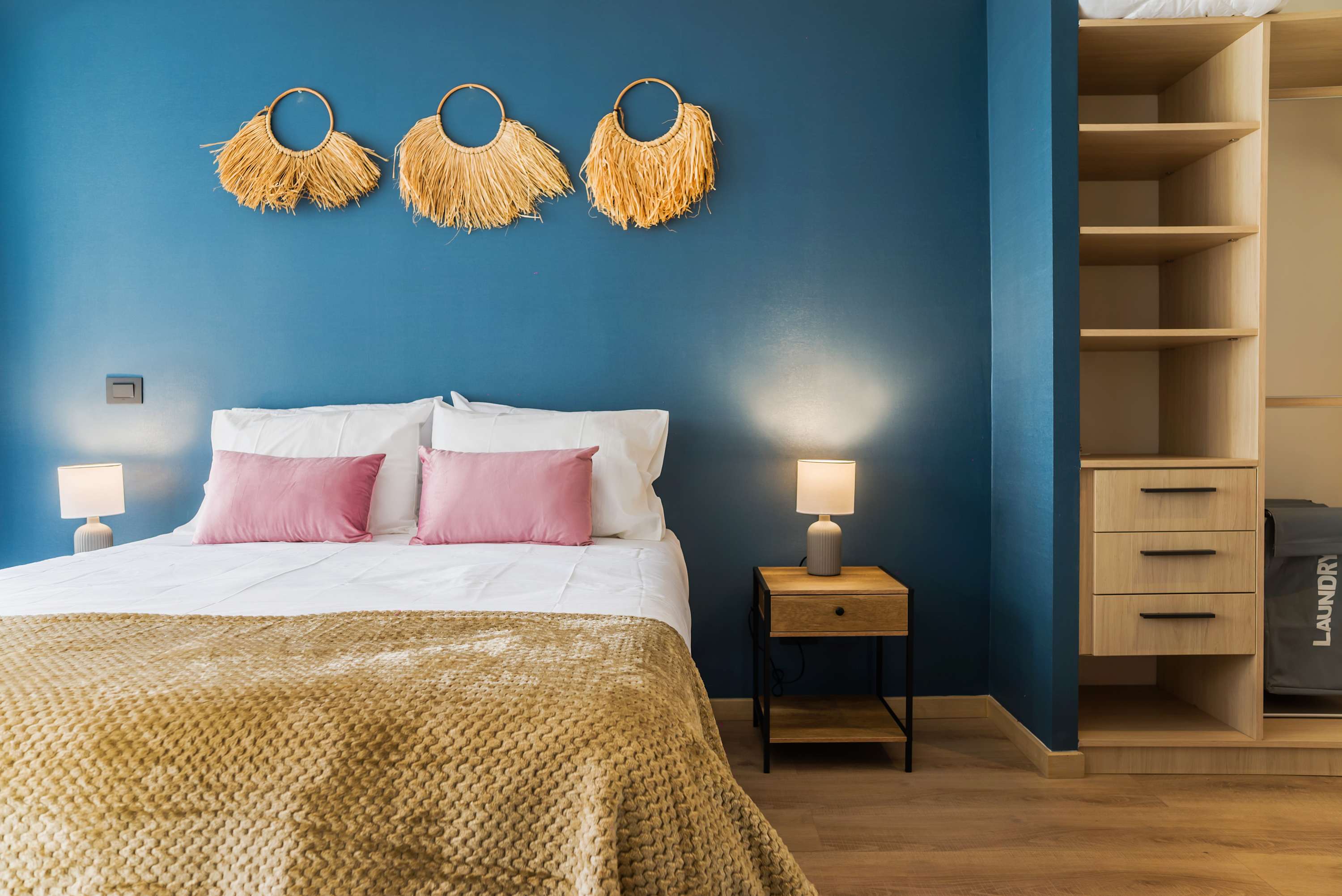 Relax in this stylish bedroom with chic decor and cozy lighting, perfect for a restful stay.
