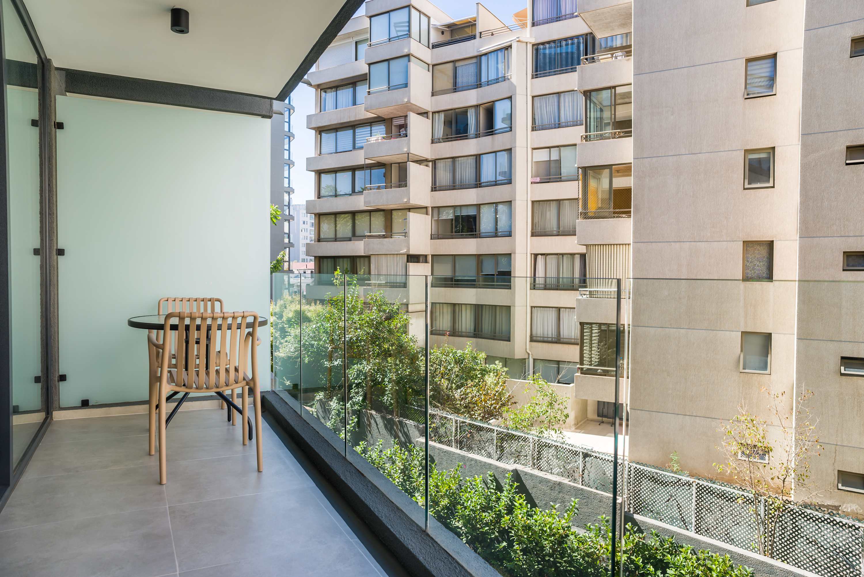 Enjoy your morning coffee on this serene private balcony with city views.