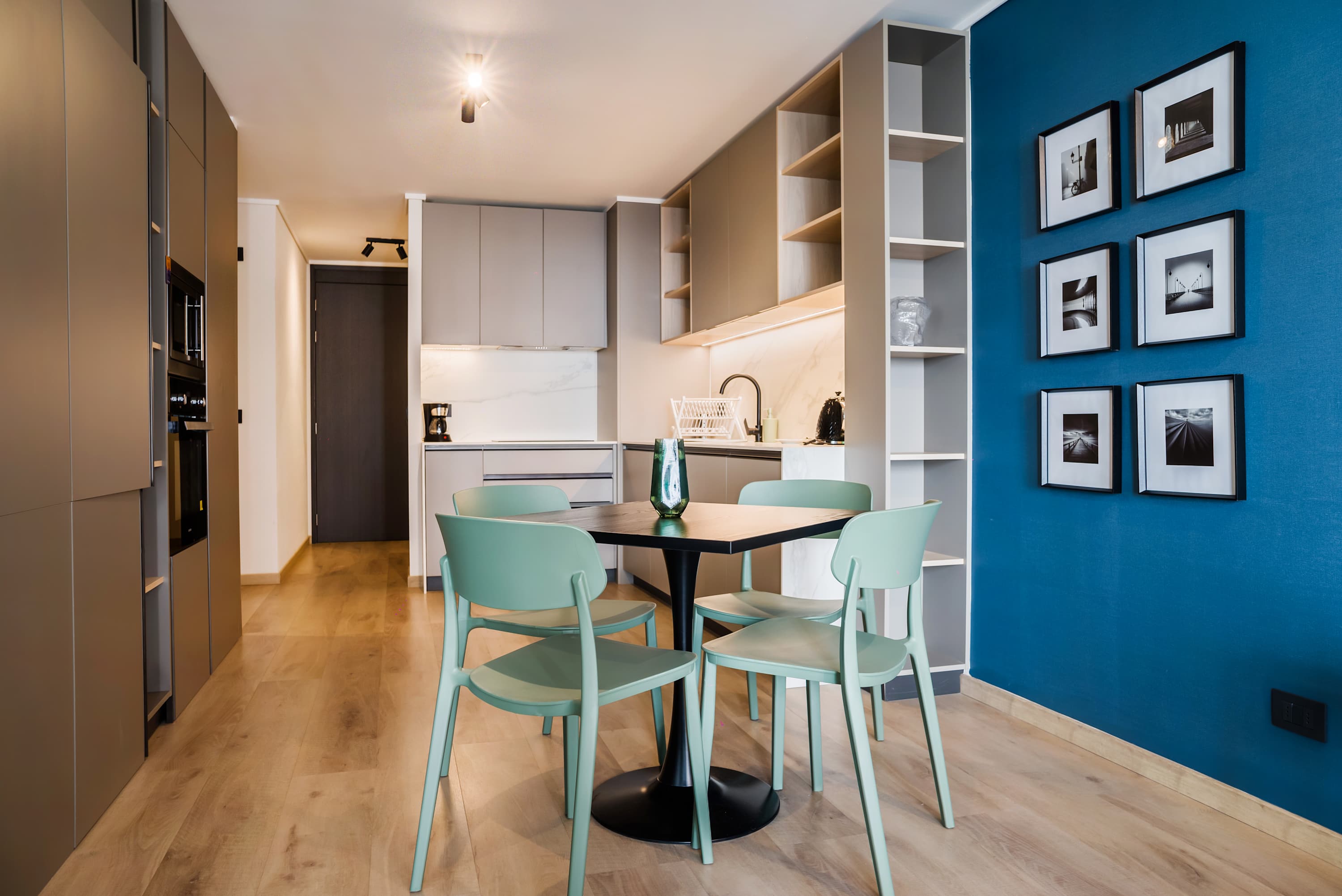 Chic, modern kitchen with stylish dining area and vibrant decor, perfect for intimate meals.