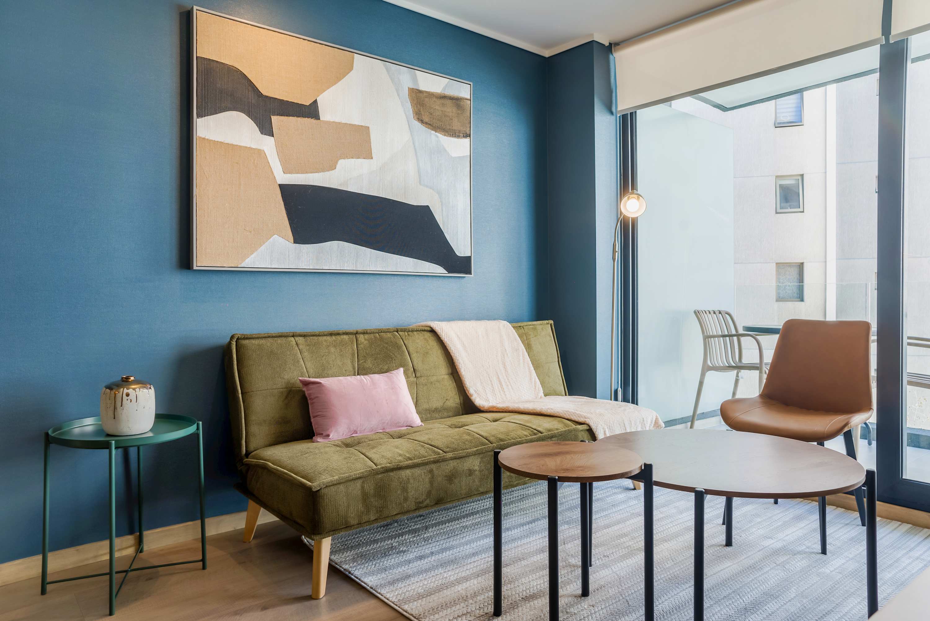 Cozy and stylish living area with modern decor and a private balcony, perfect for relaxation.