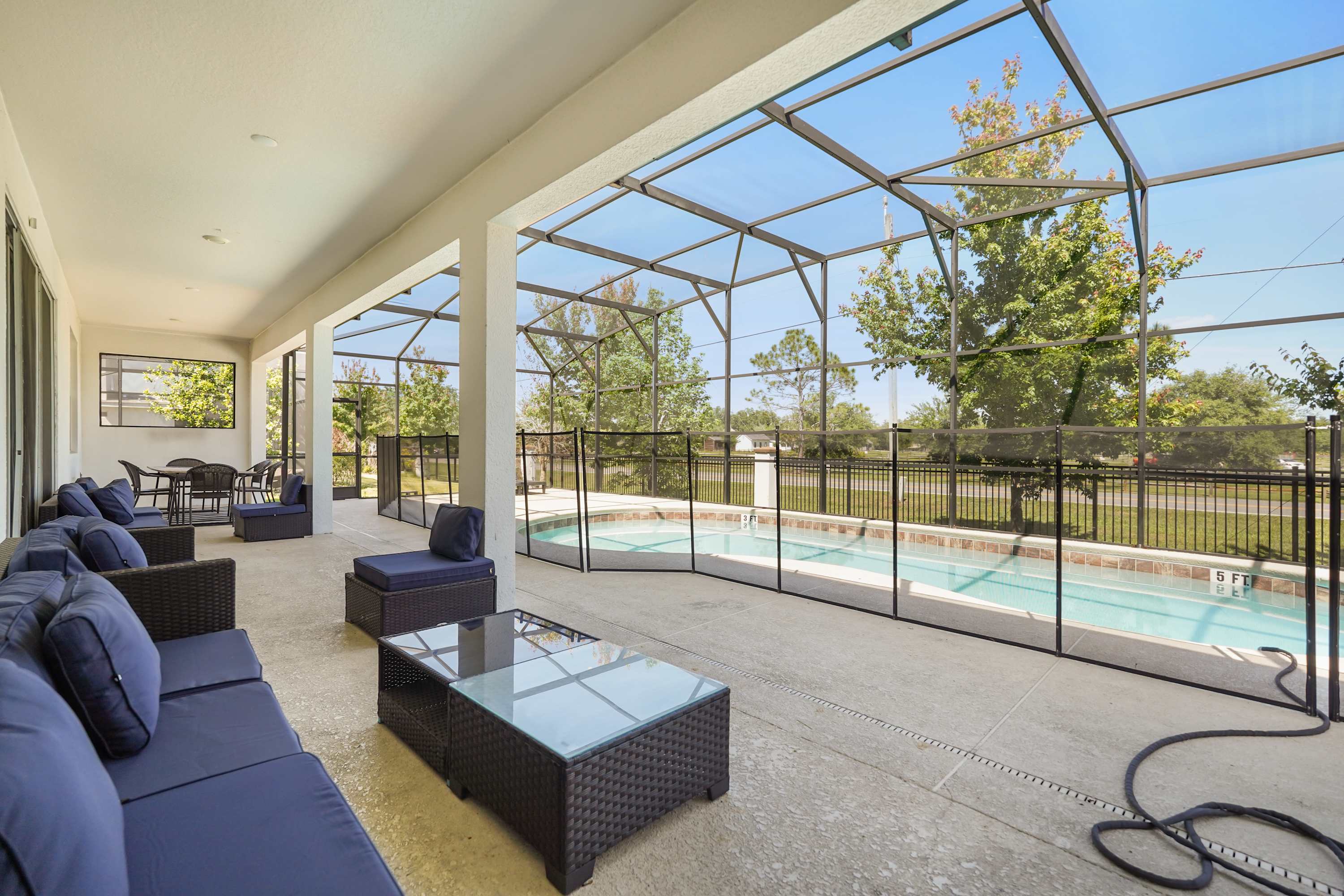 Relax in style on the spacious patio overlooking a private pool, perfect for gatherings and enjoying the outdoors.