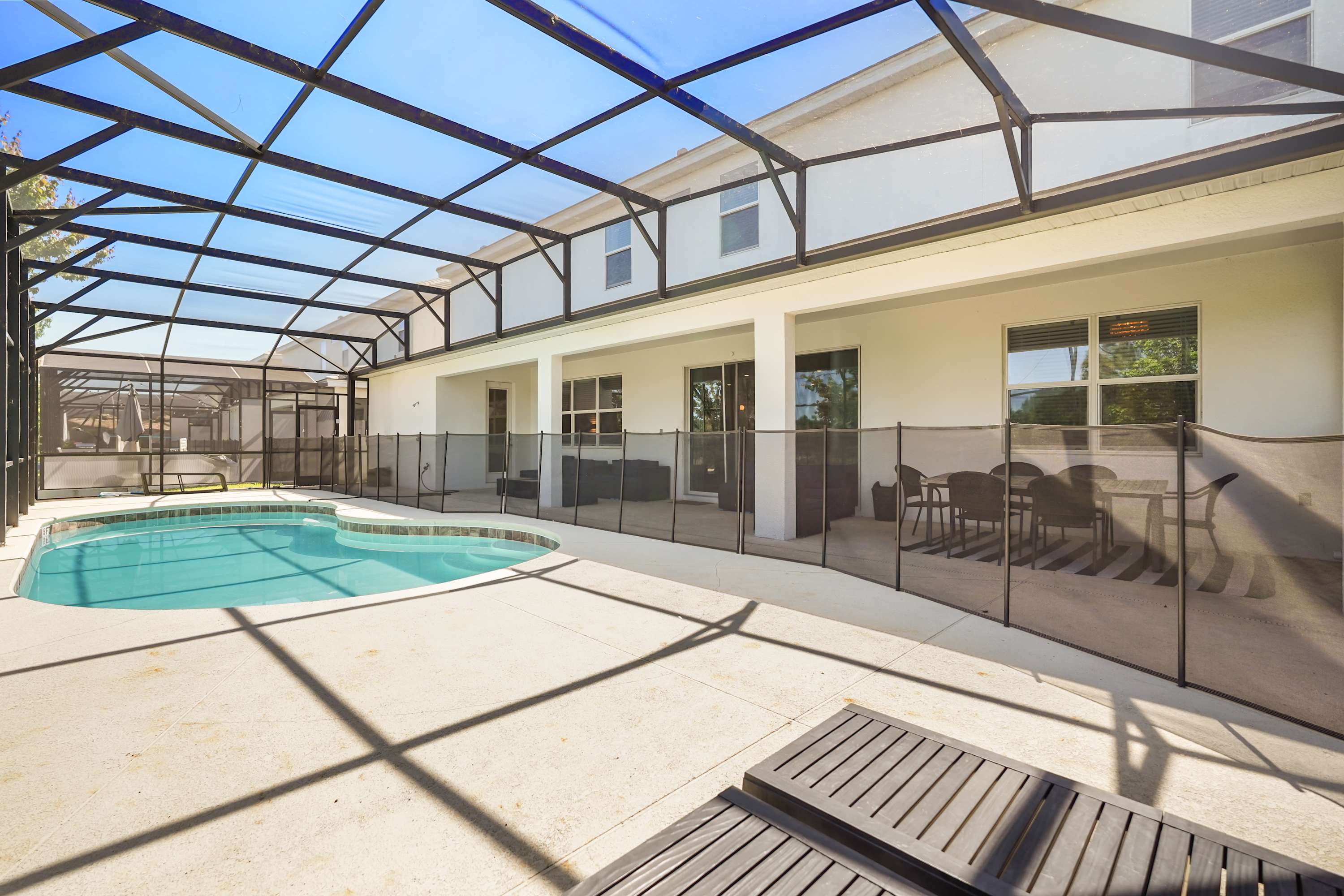Relax by your private pool oasis, complete with a safety fence and ample seating for outdoor dining and lounging.