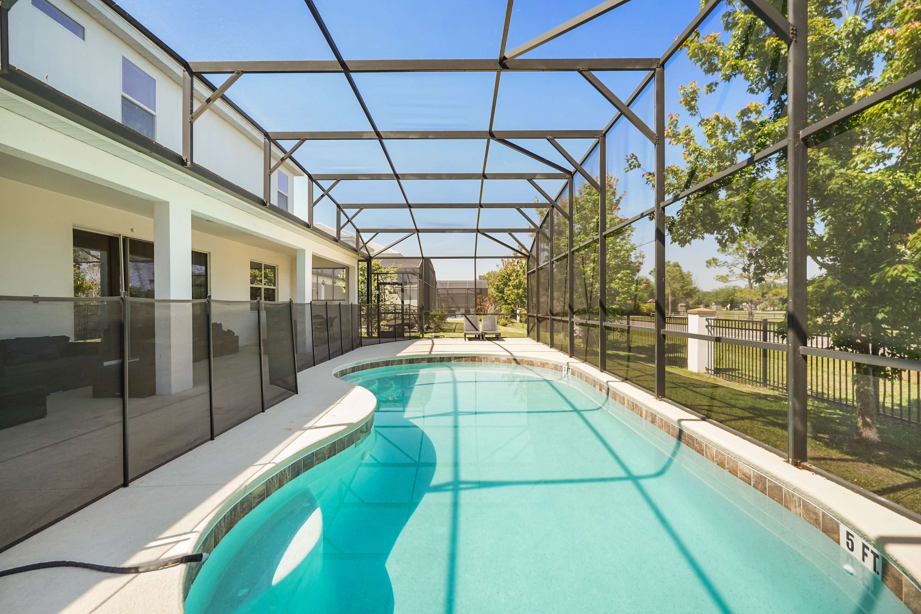 Enjoy a refreshing dip in your private screened-in pool, perfect for relaxation and family fun.