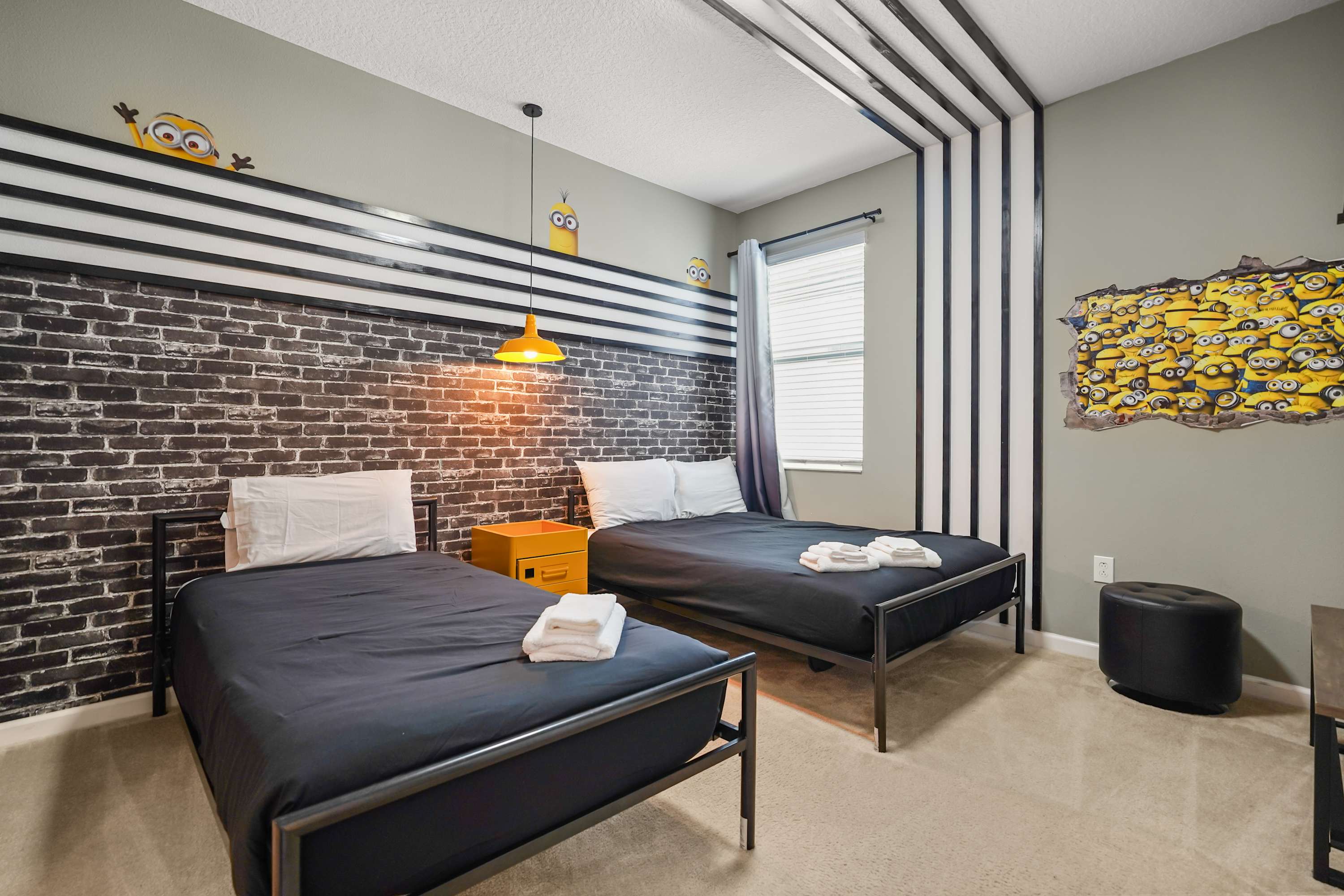 Delight in this fun Minion-themed bedroom, perfect for kids and fans alike, offering cozy twin beds and playful decor.