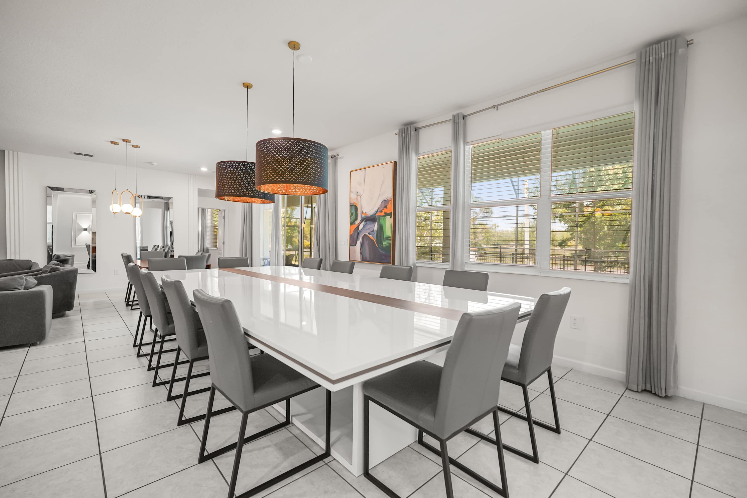 Elegant dining area perfect for large gatherings, featuring a sleek table and modern lighting.