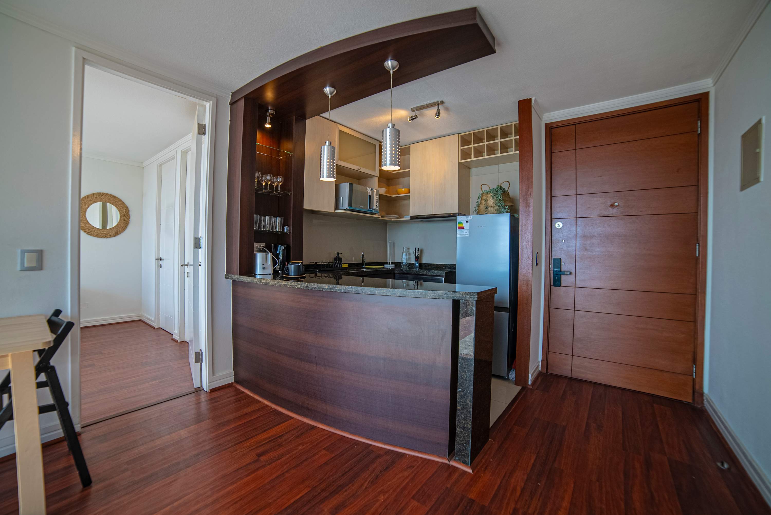 Cozy kitchen with modern amenities and stylish wooden accents, perfect for preparing meals during your stay.