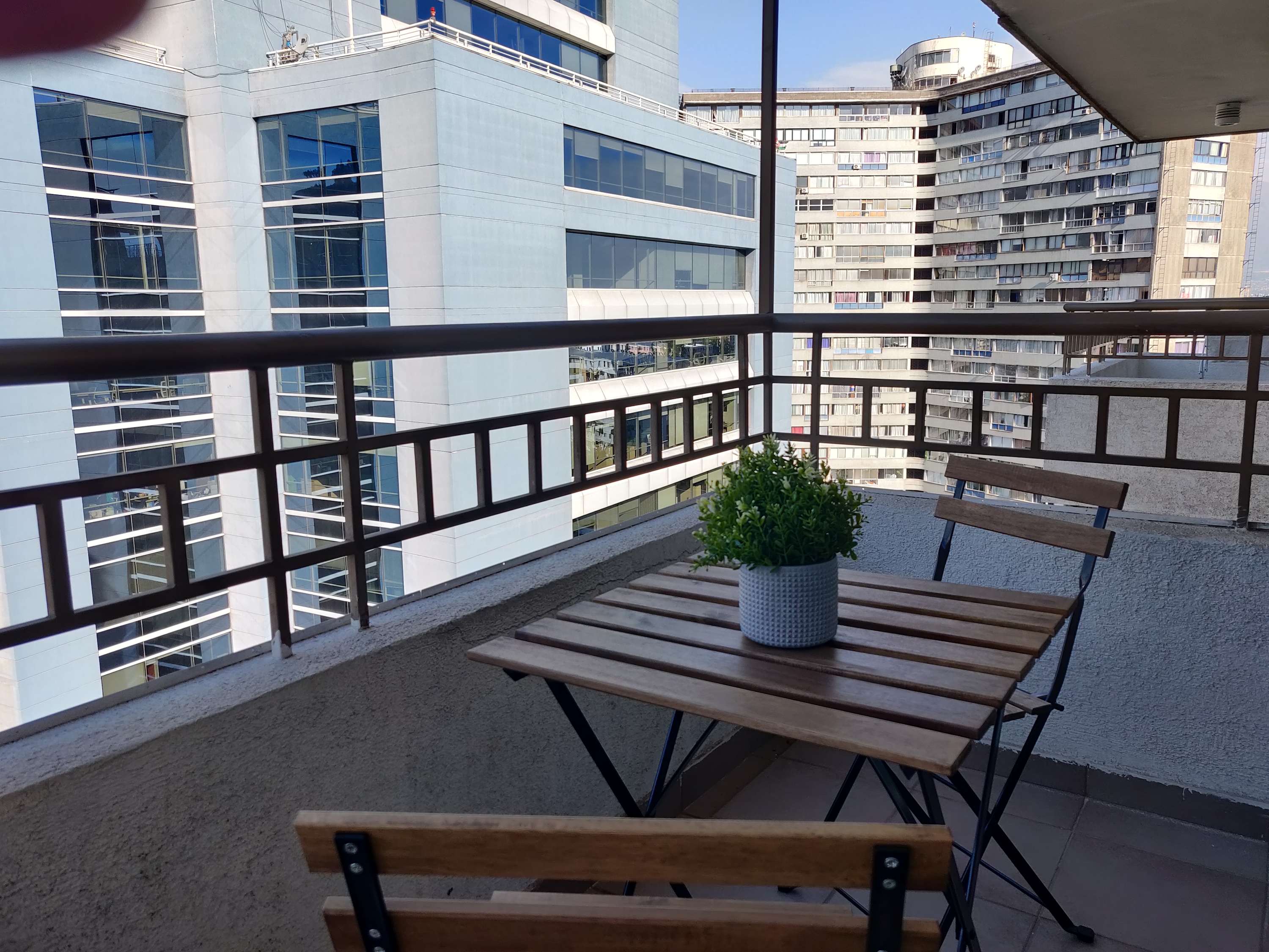 Enjoy your morning coffee with city views from this cozy balcony retreat.