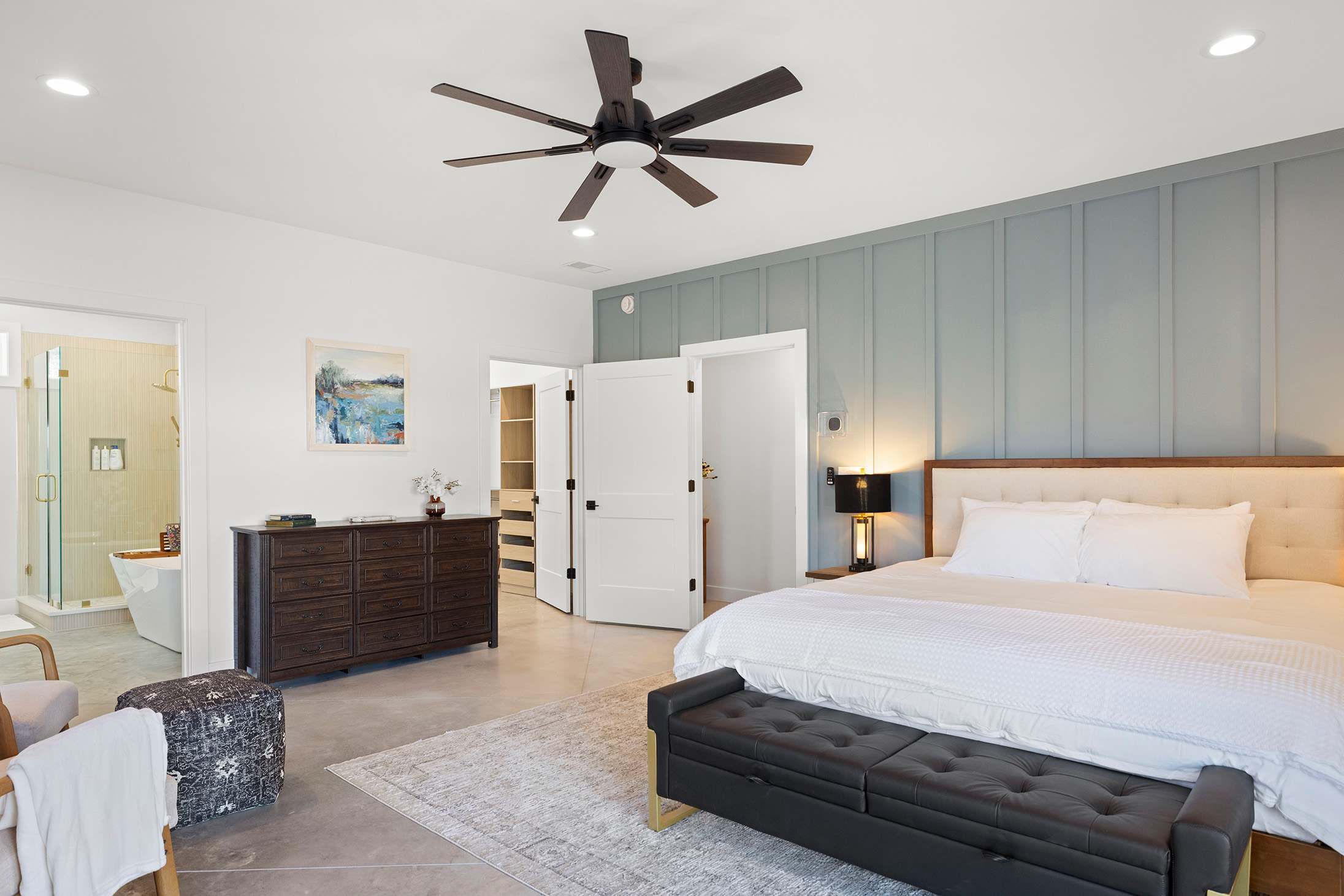 A spacious king bedroom with an ensuite bathroom and walk in closet.
