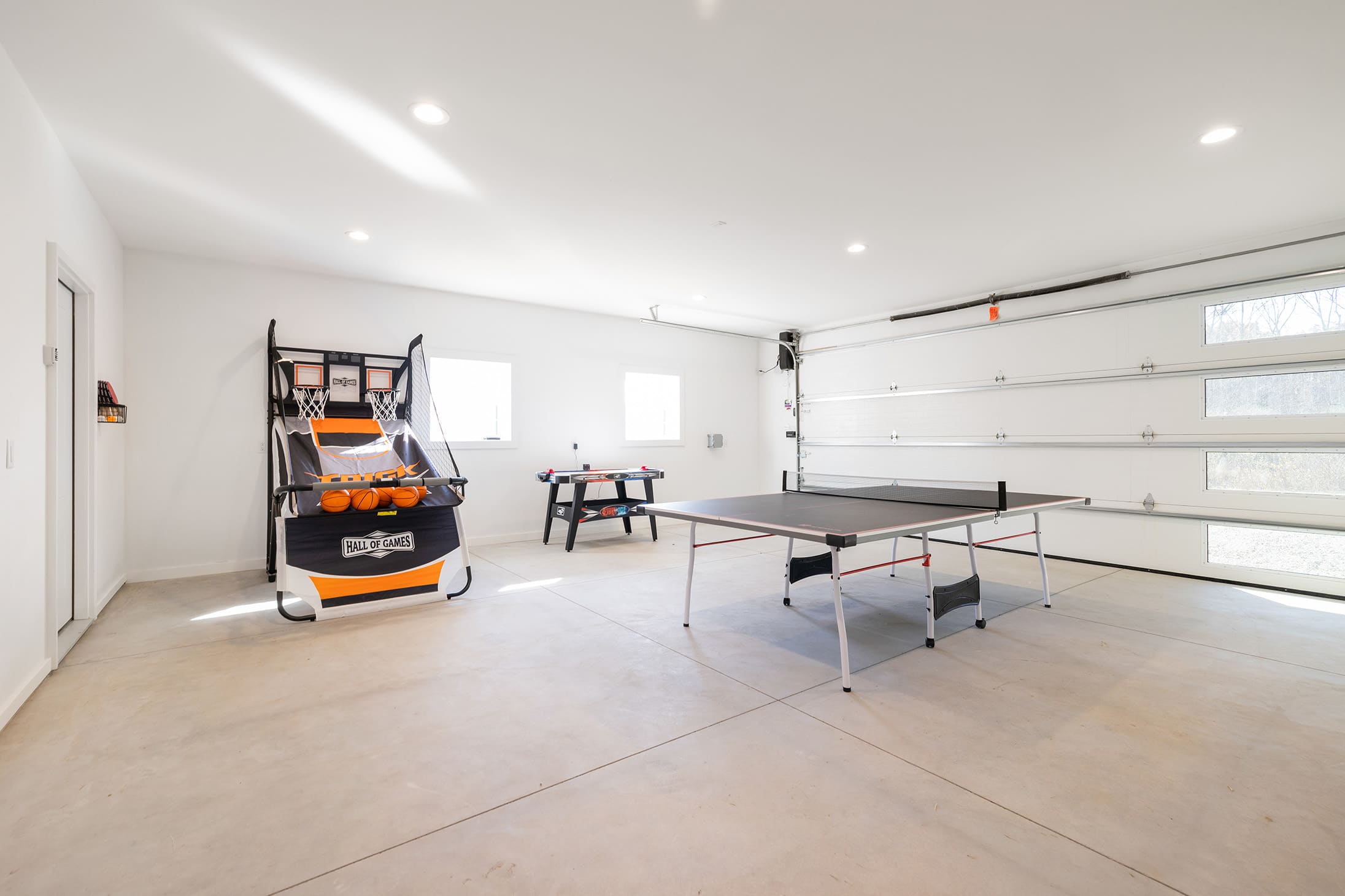 Challenge friends to basketball and ping pong in this bright game space.