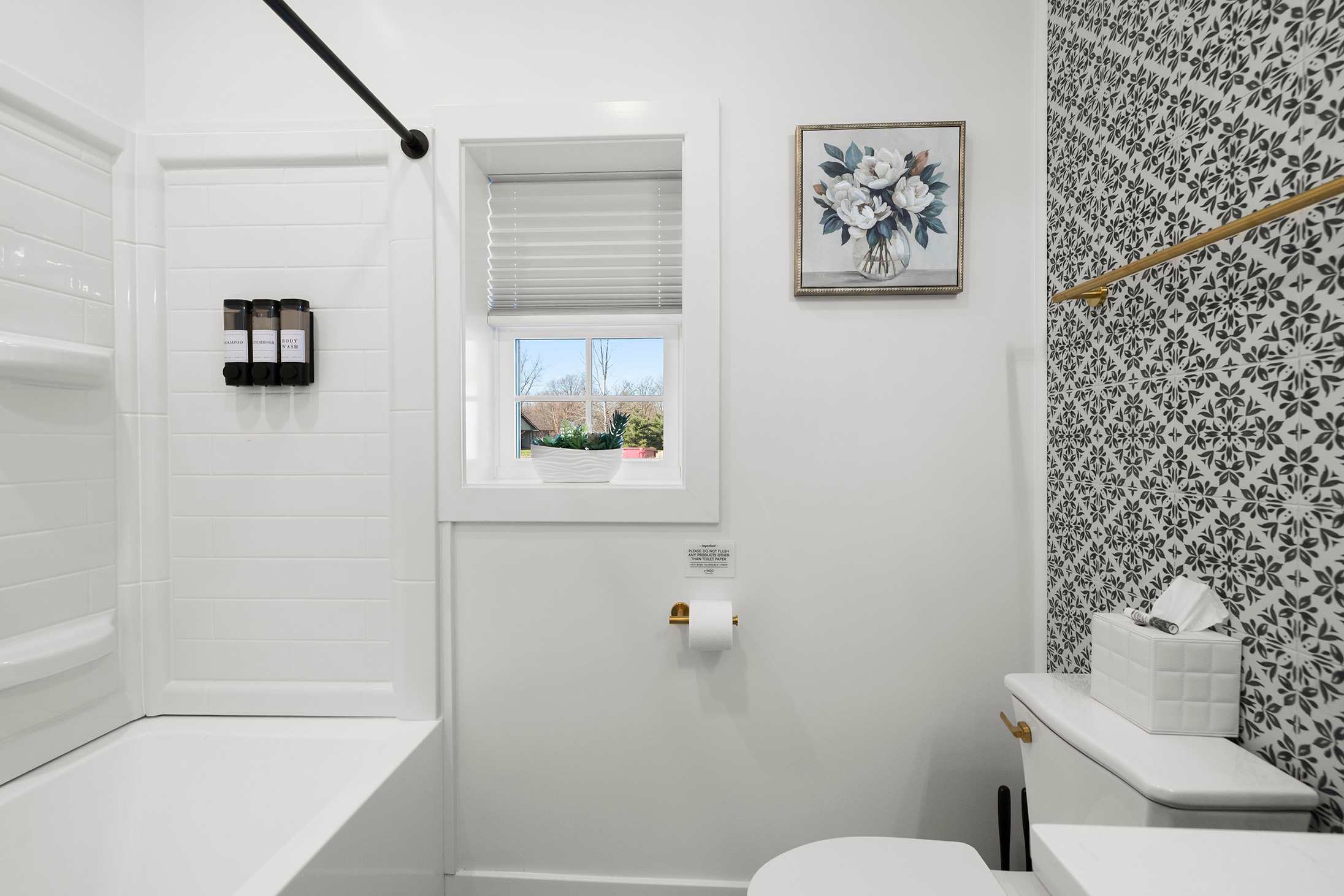 Enjoy a soothing rinse in this clean light filled bath.