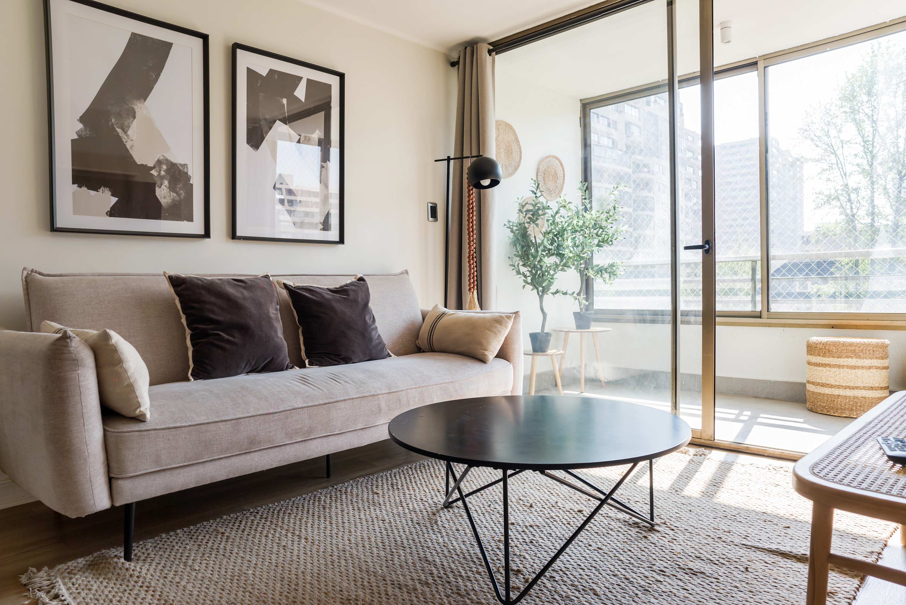 Bright and stylish living area with modern decor and balcony access, perfect for relaxation.