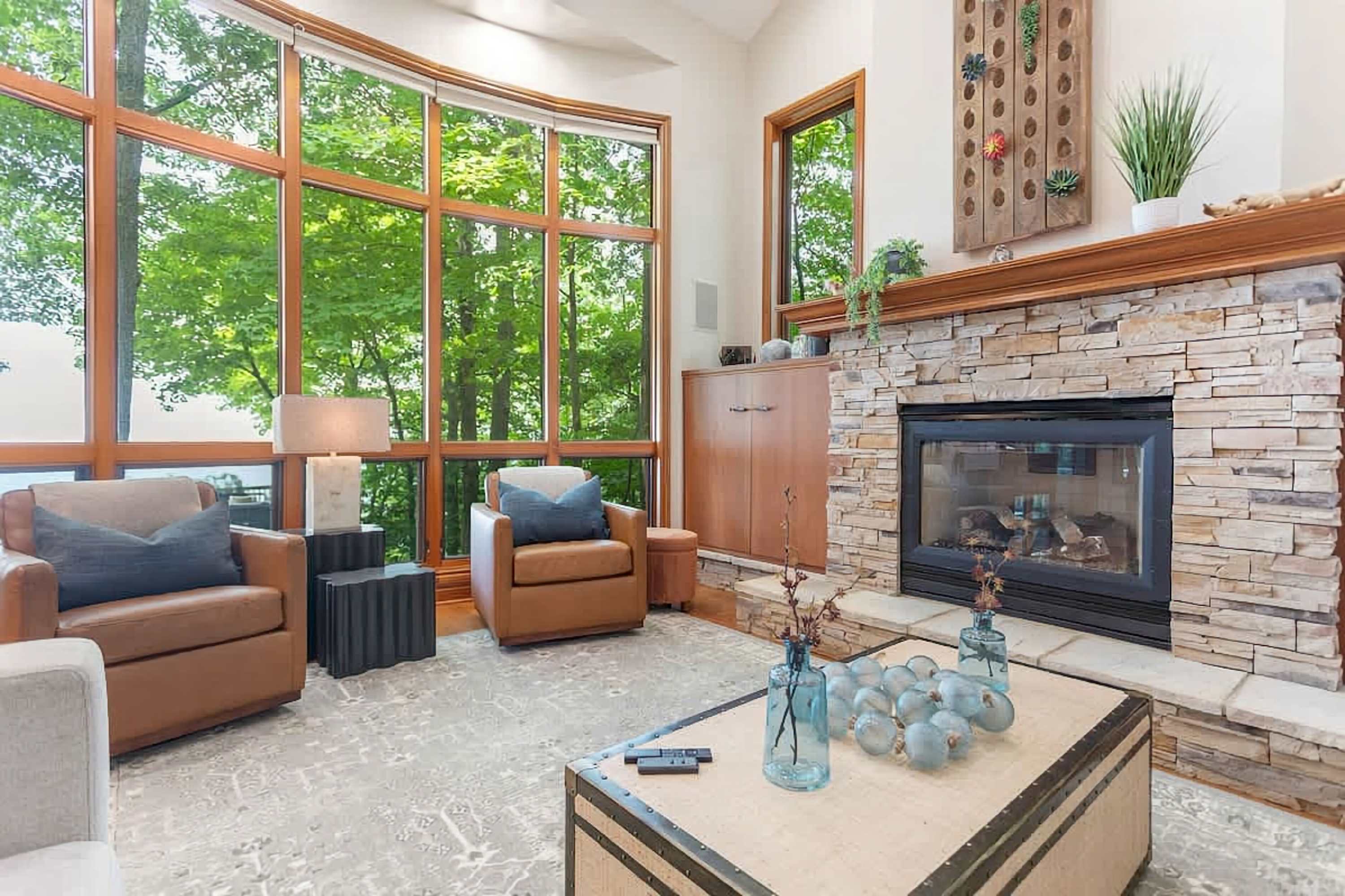Two chairs against the beautiful back drop of Lake Michigan sit by the fireplace. The perfect spot to curl up with a book or start a conversation.