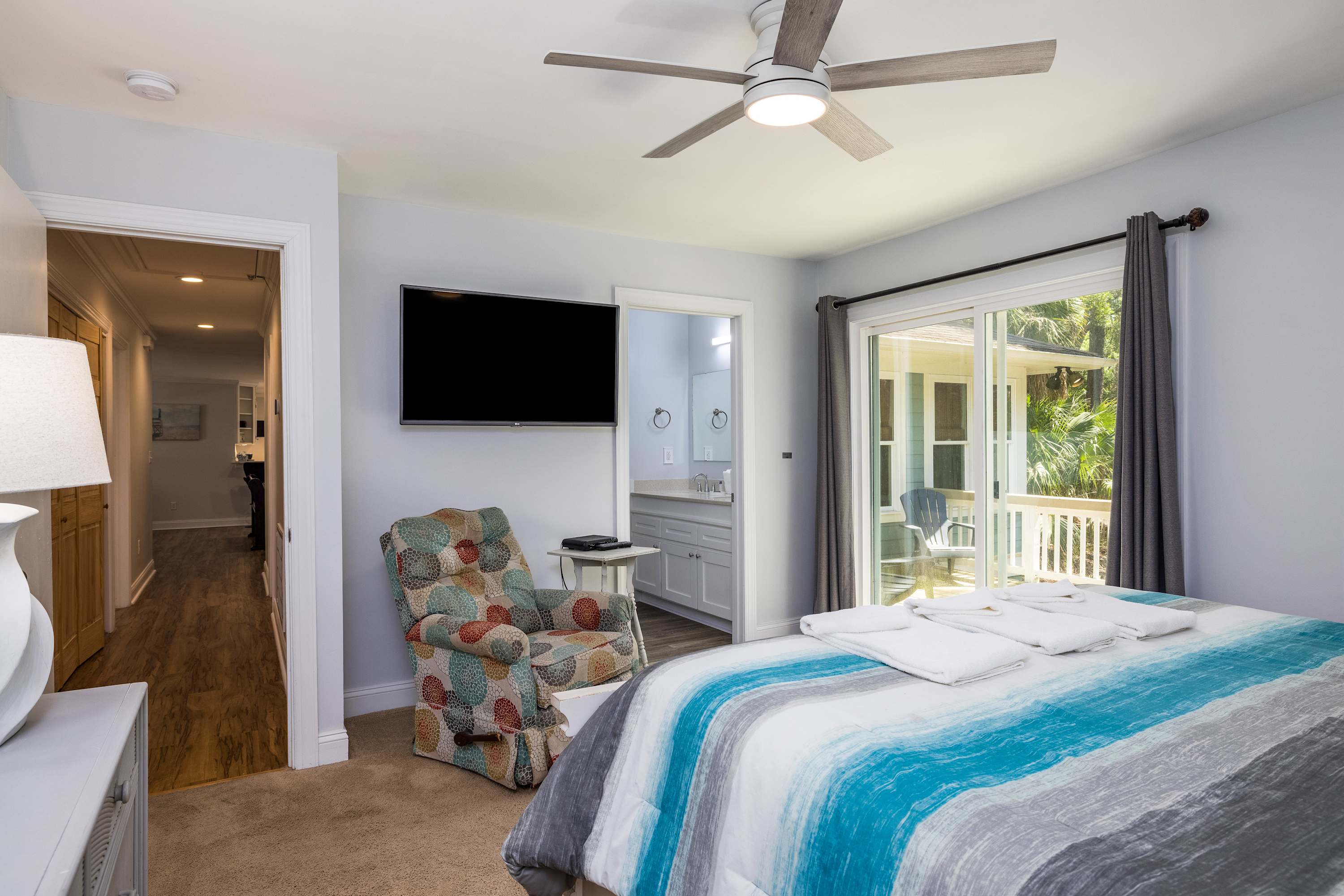 Primary Bedroom with King Bed and Full En Suite Bathroom with Access to Back Patio