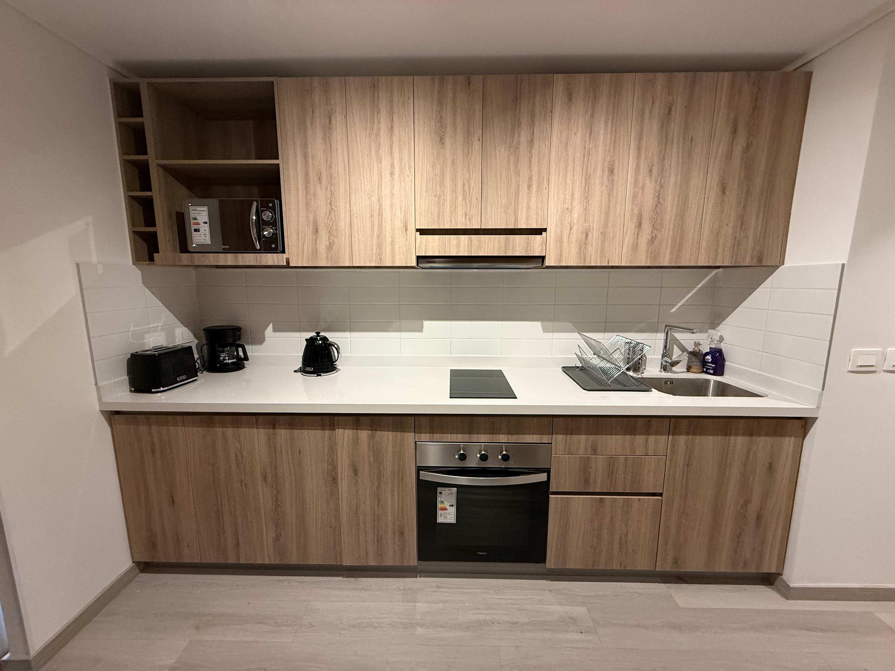 Modern kitchen with sleek appliances and ample storage, perfect for cooking your favorite meals.