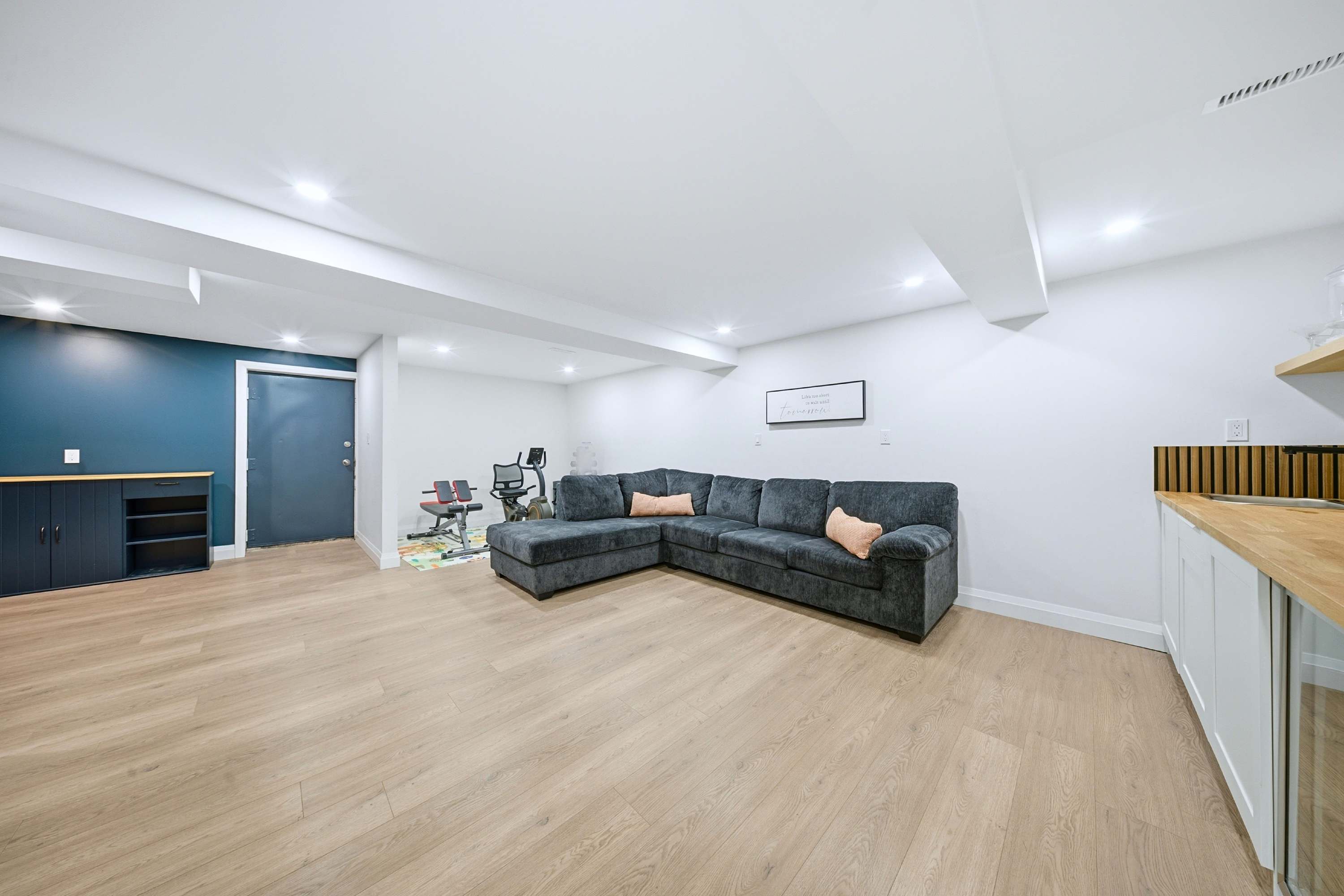 Flexible living space with integrated exercise area for guest use