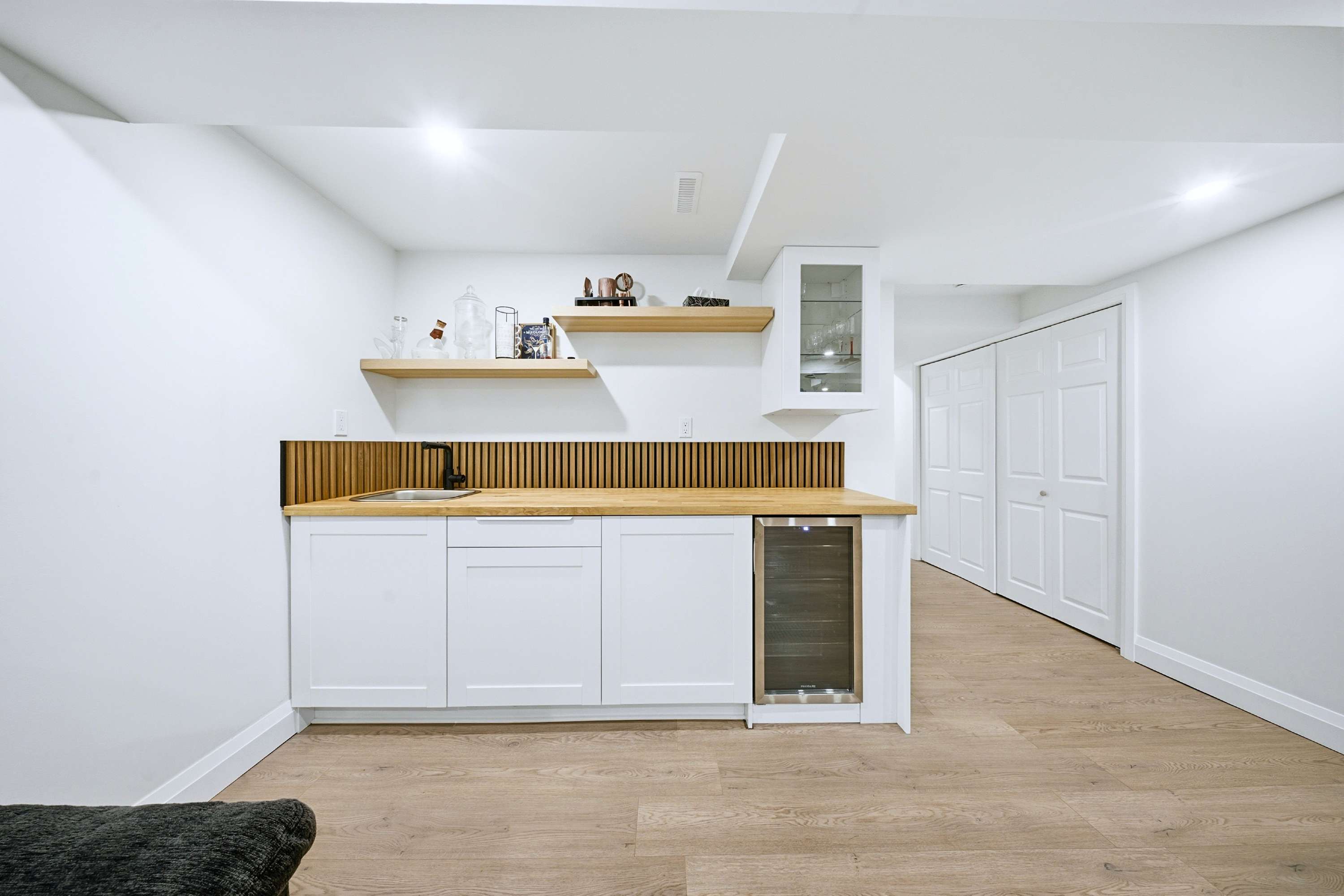 Guest refreshment station with sink and chiller for easy access anytime